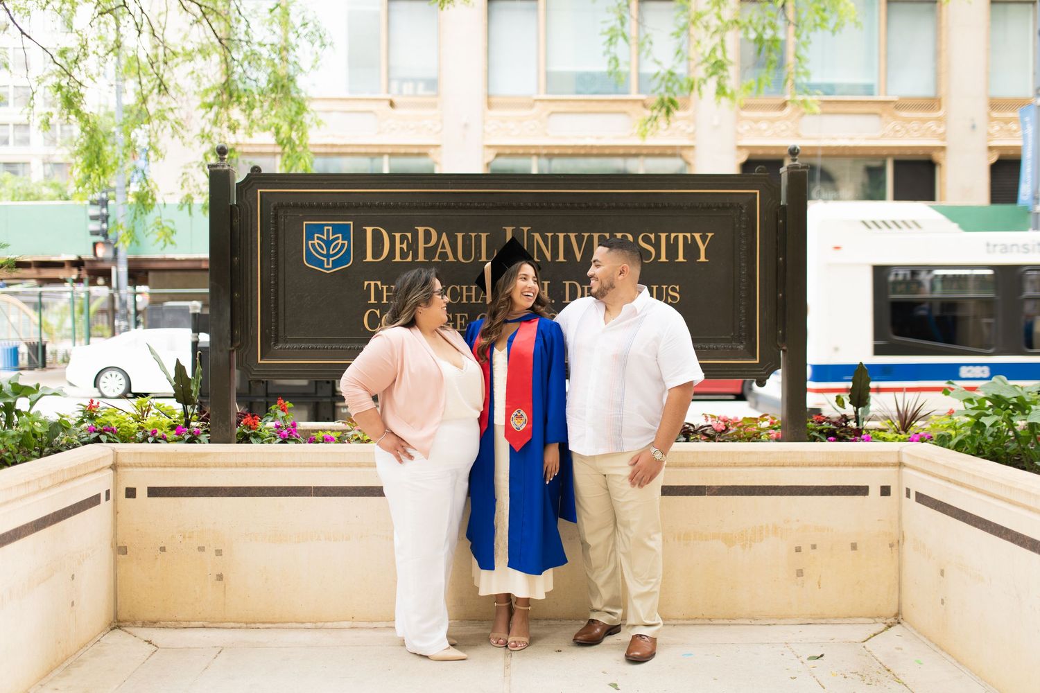 DePaul University campus entrance with signage and greenery.