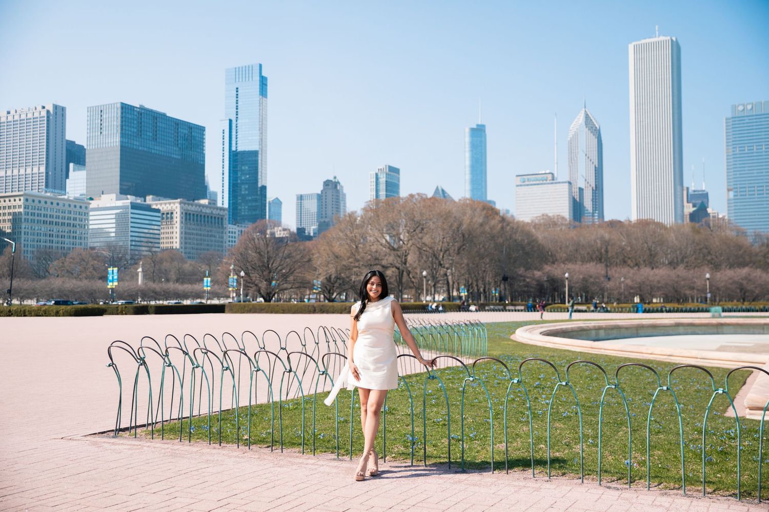 Panoramic view of Chicago skyline with person walking along lakefront path.