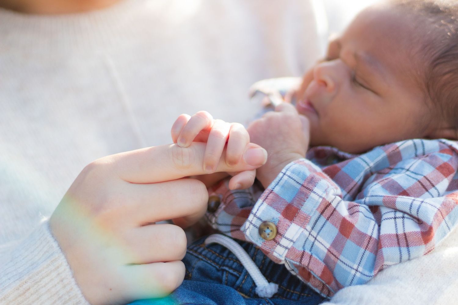A series of images showing a pacifier being gently placed into a sleeping baby's mouth.