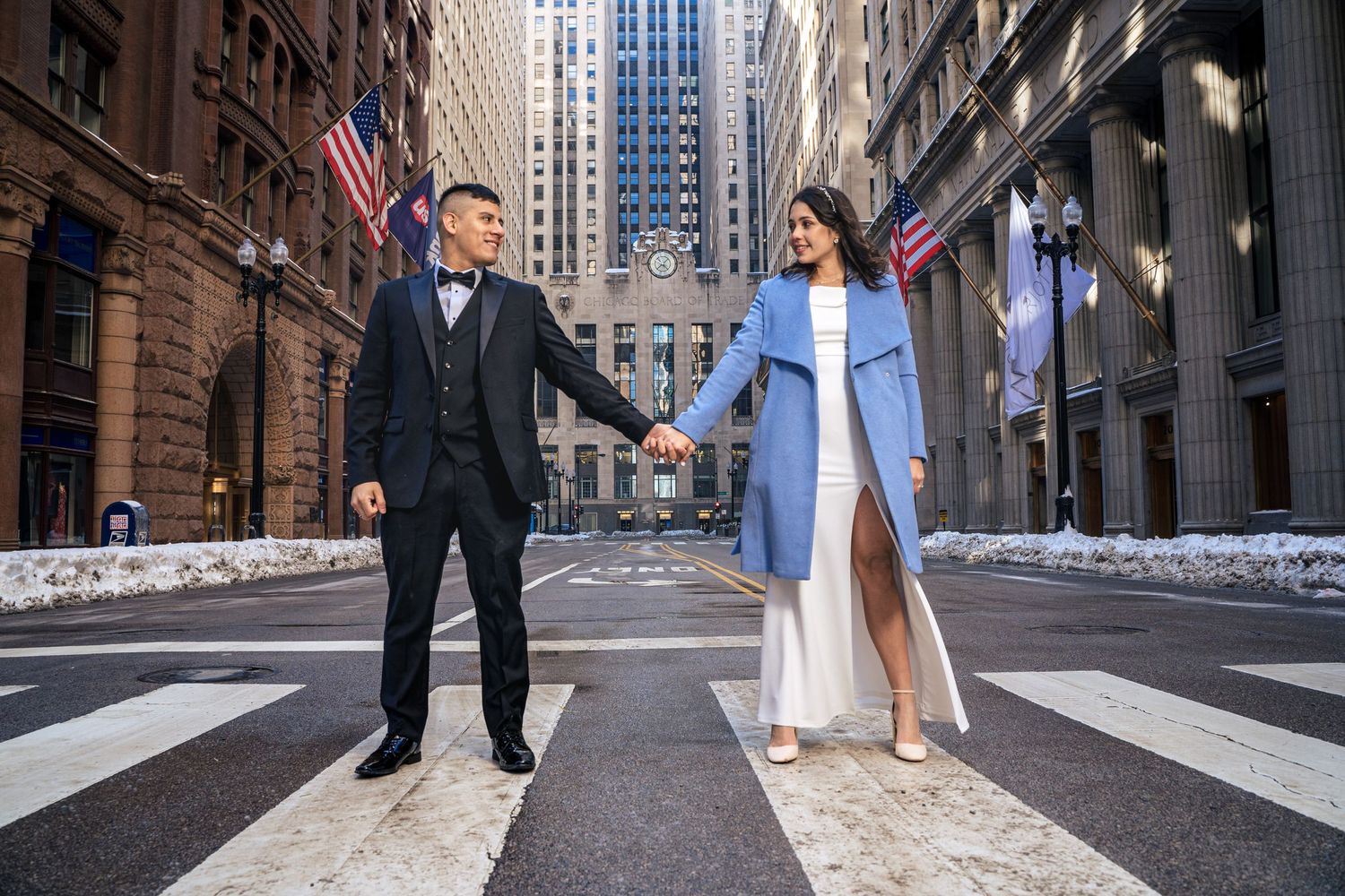 Urban wedding photography in downtown city street with historic architecture.