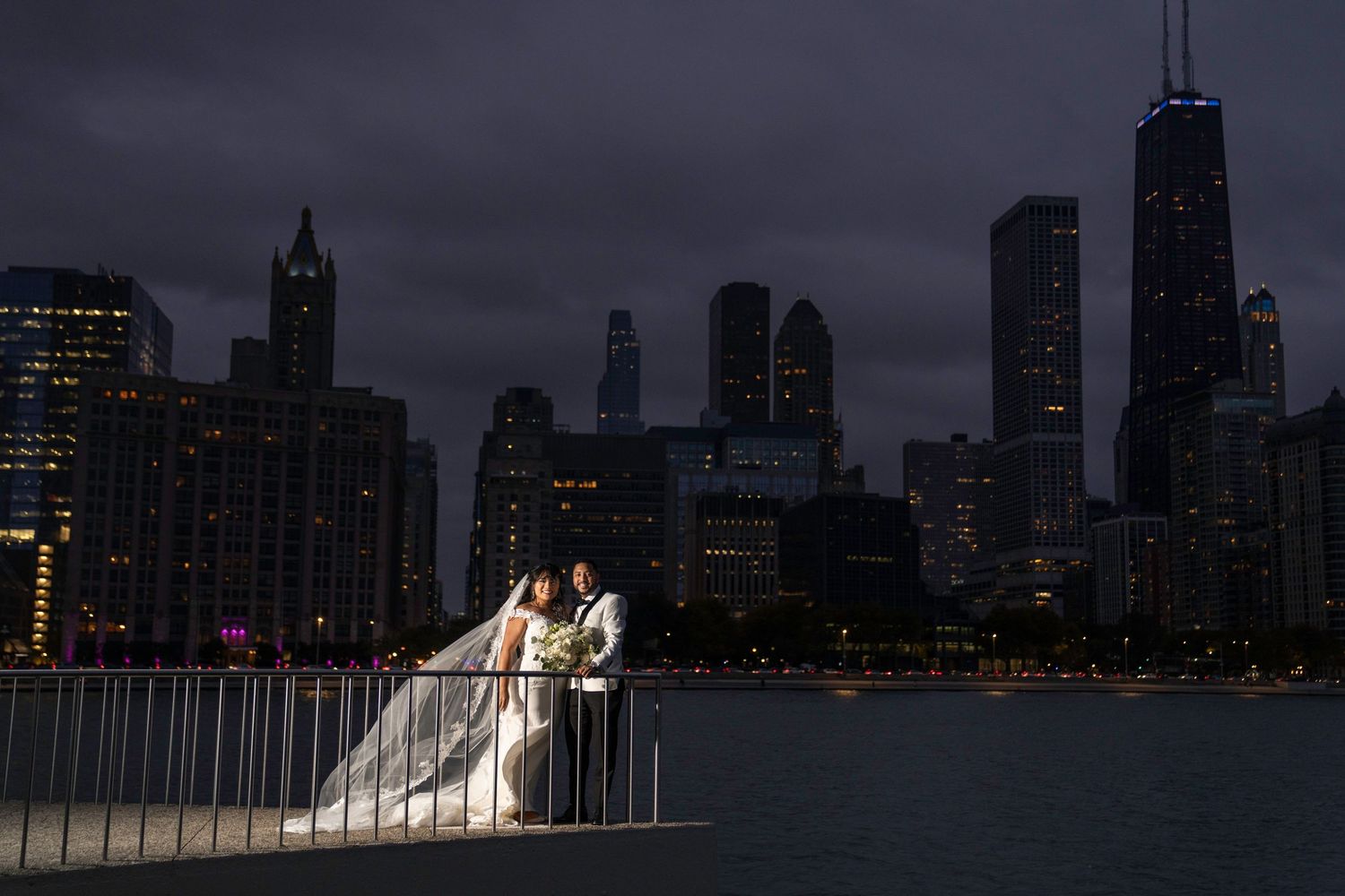 Chicago skyline at dusk provides dramatic backdrop for wedding photography.