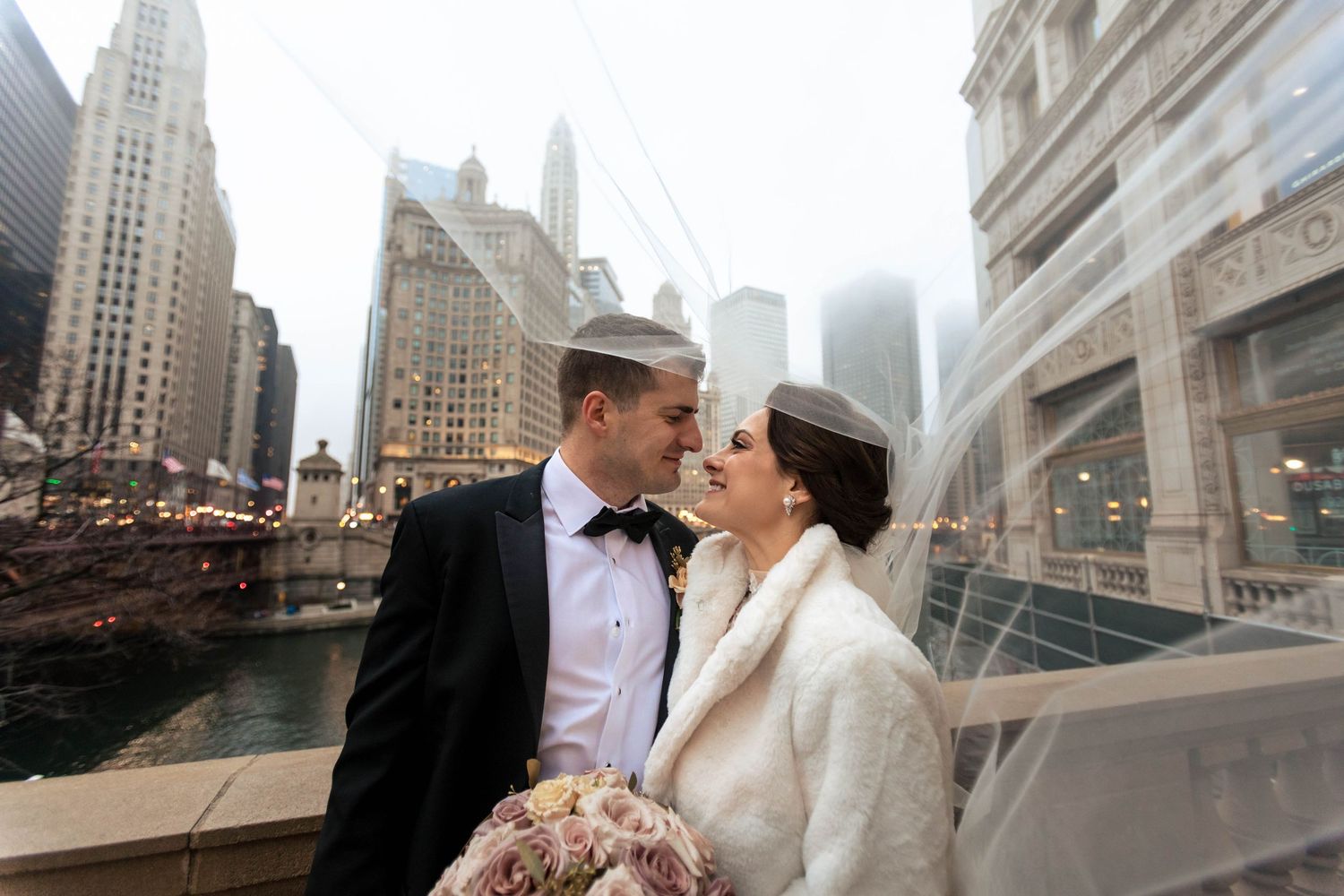 Newlyweds sharing intimate moment against Chicago cityscape backdrop.