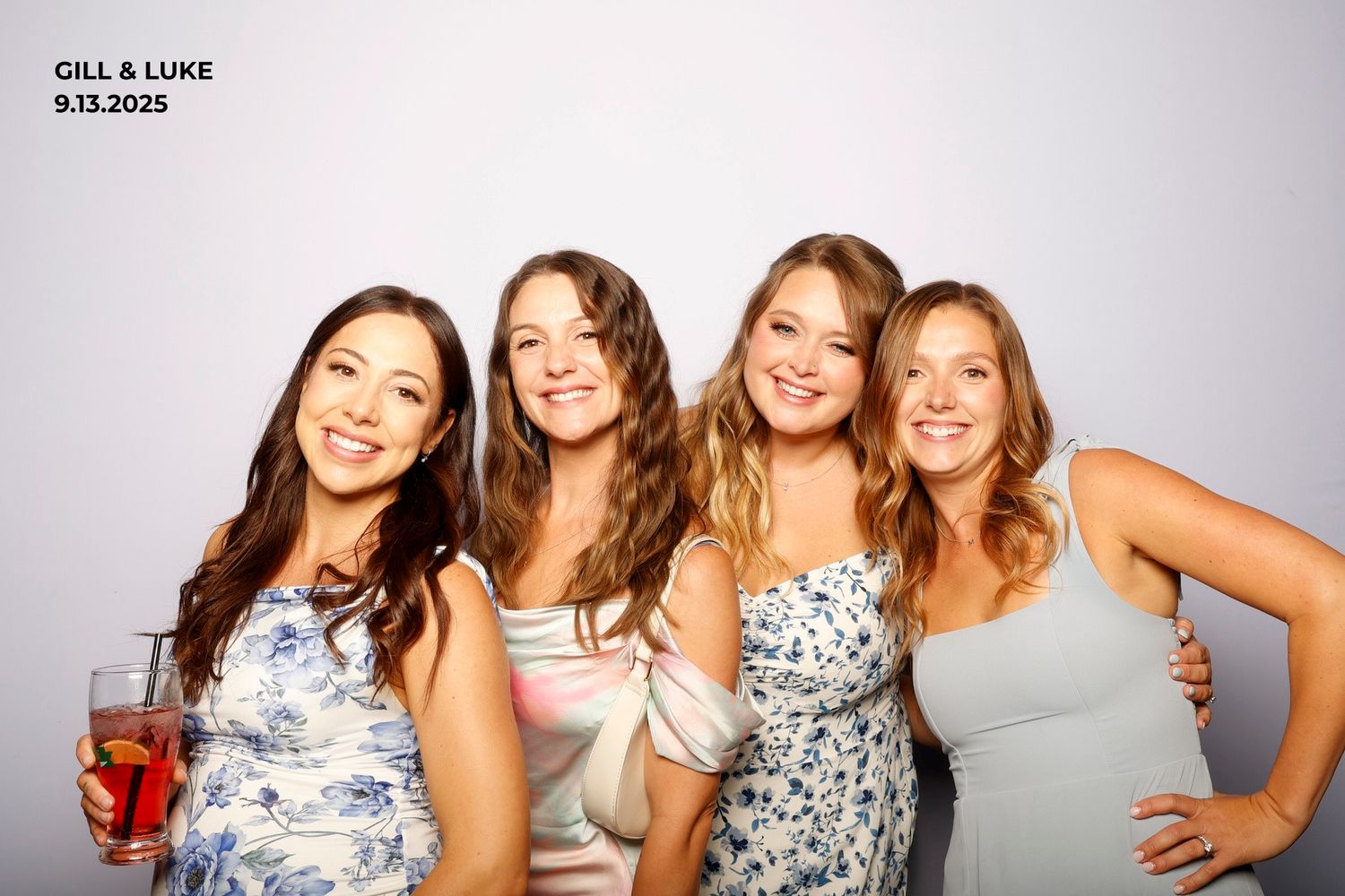 A group of friends in floral dresses pose together in a photo booth sequence of six connected images.