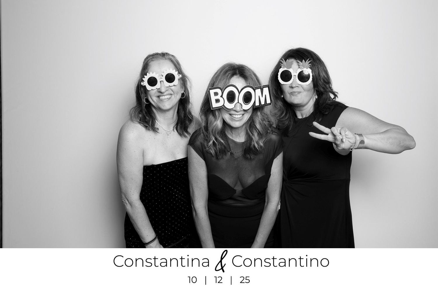Wedding guests pose together in a series of black and white photo booth style snapshots showing joyful expressions.