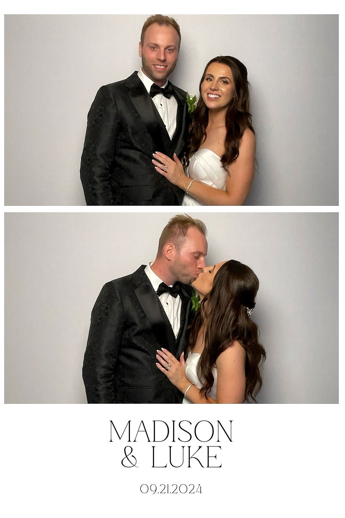 A couple poses together in formal black and white wedding attire against a light colored studio backdrop for portraits.