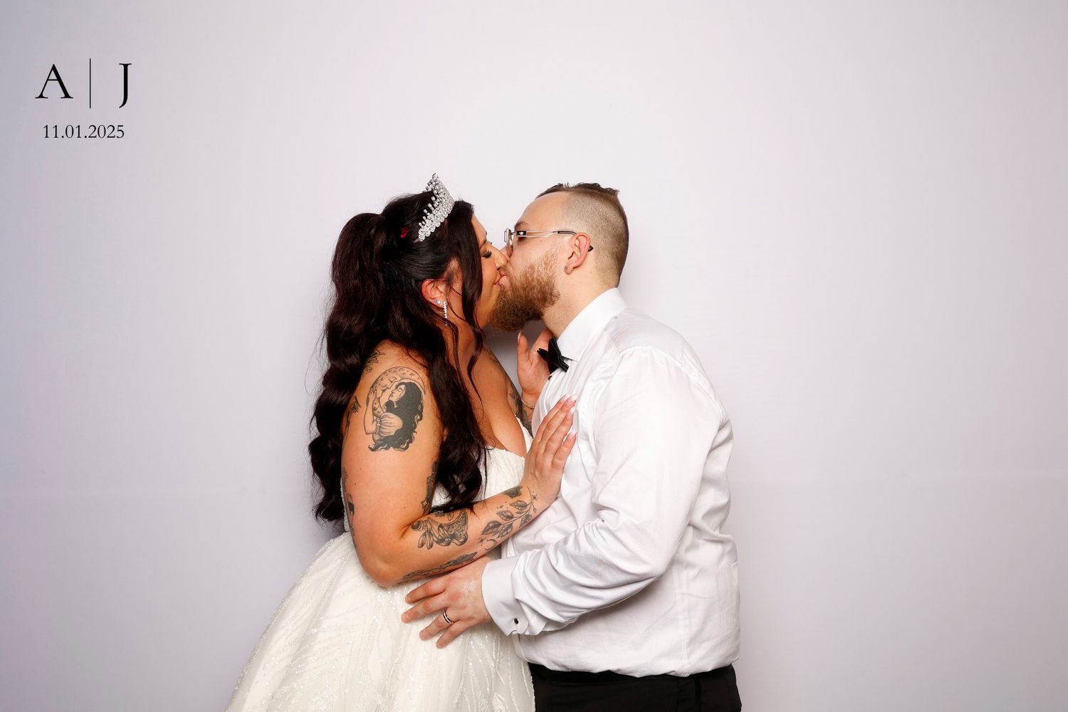 A couple shares an intimate dance pose in formal attire against a white studio backdrop.