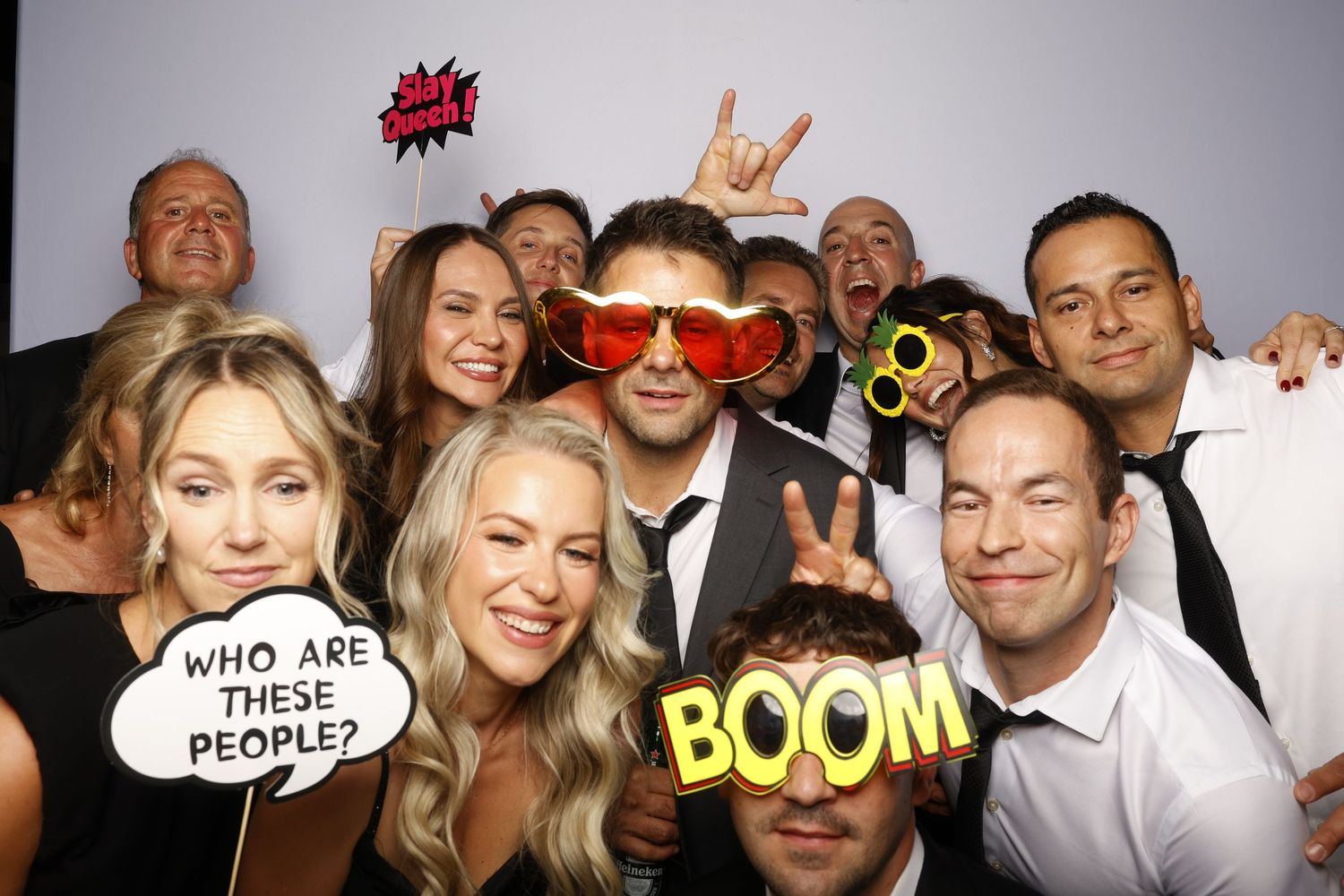 Photo booth strip showing party guests making silly faces and poses against a white backdrop.