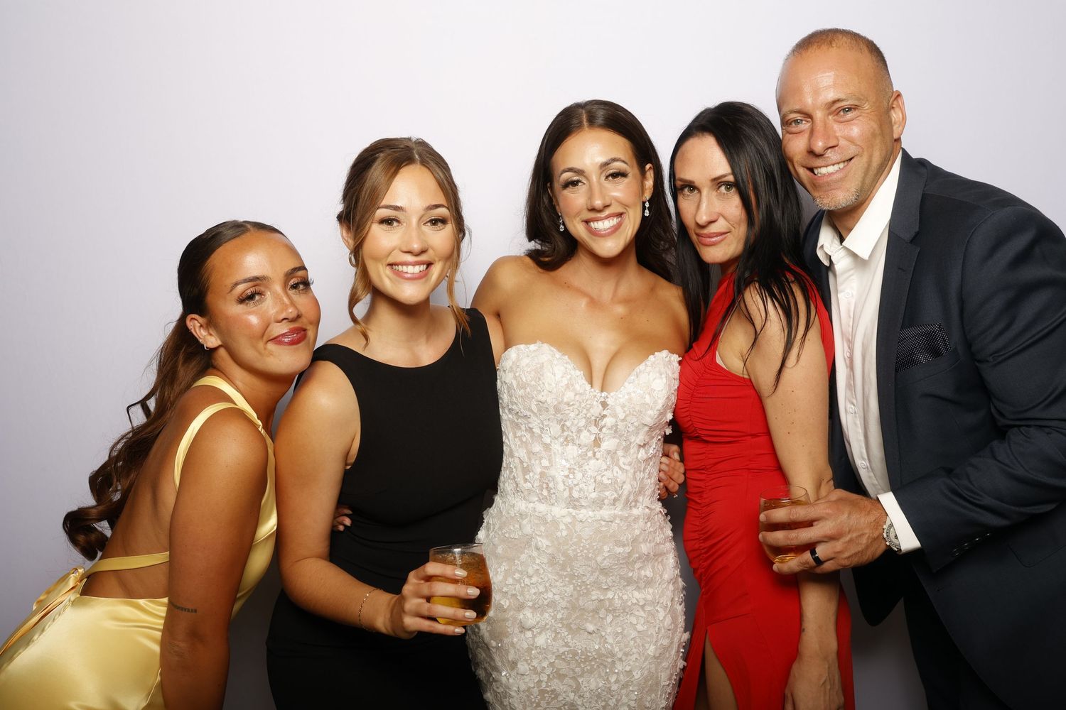 A series of photo booth style images showing wedding guests posing and celebrating at a reception.