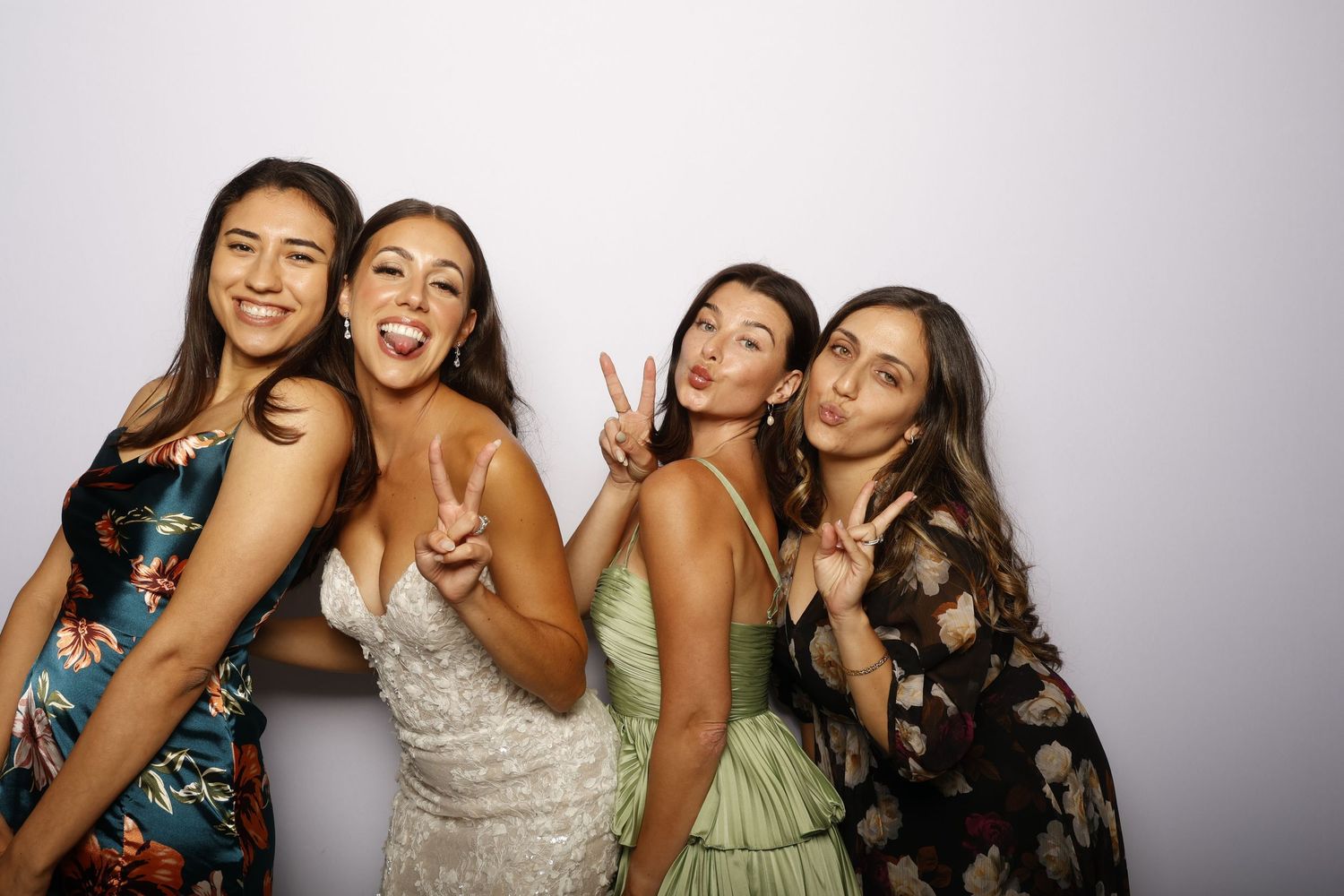 A group of friends posing together in a photo booth series showing playful and candid moments.