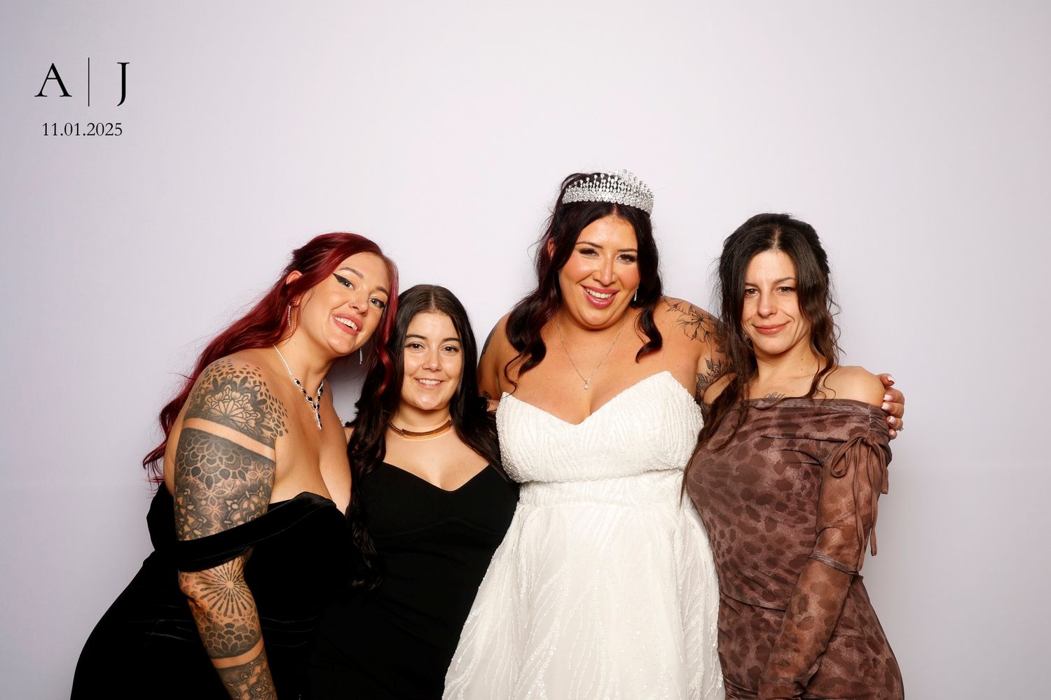 A group of people pose together at a social gathering wearing elegant evening attire.