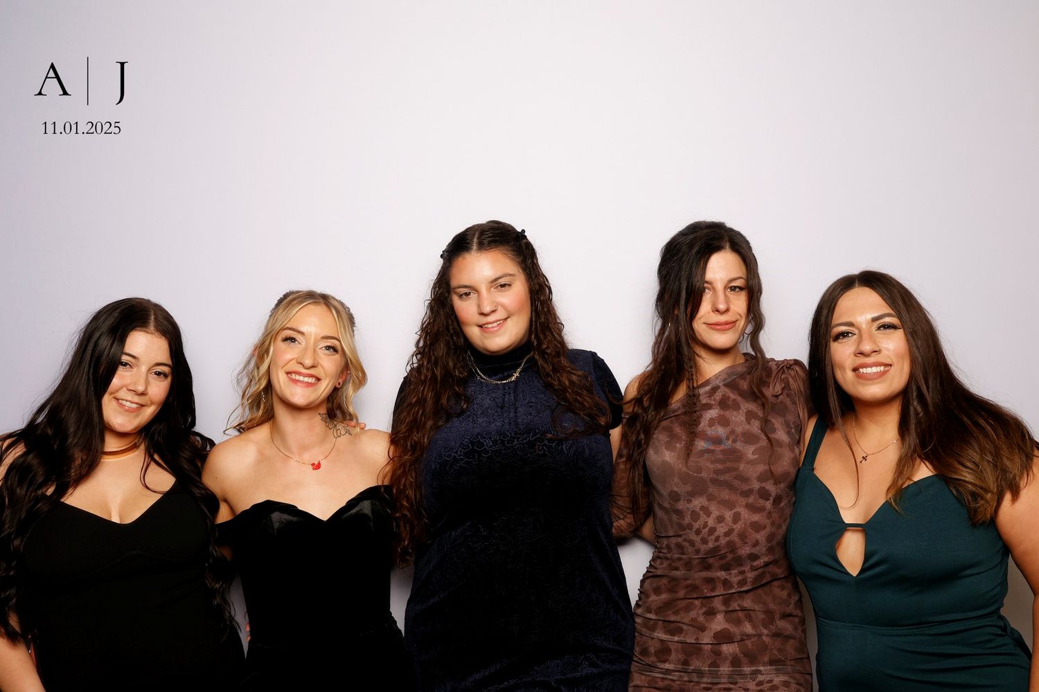 A group of friends pose together at a photo booth with various expressions and poses against a light background.
