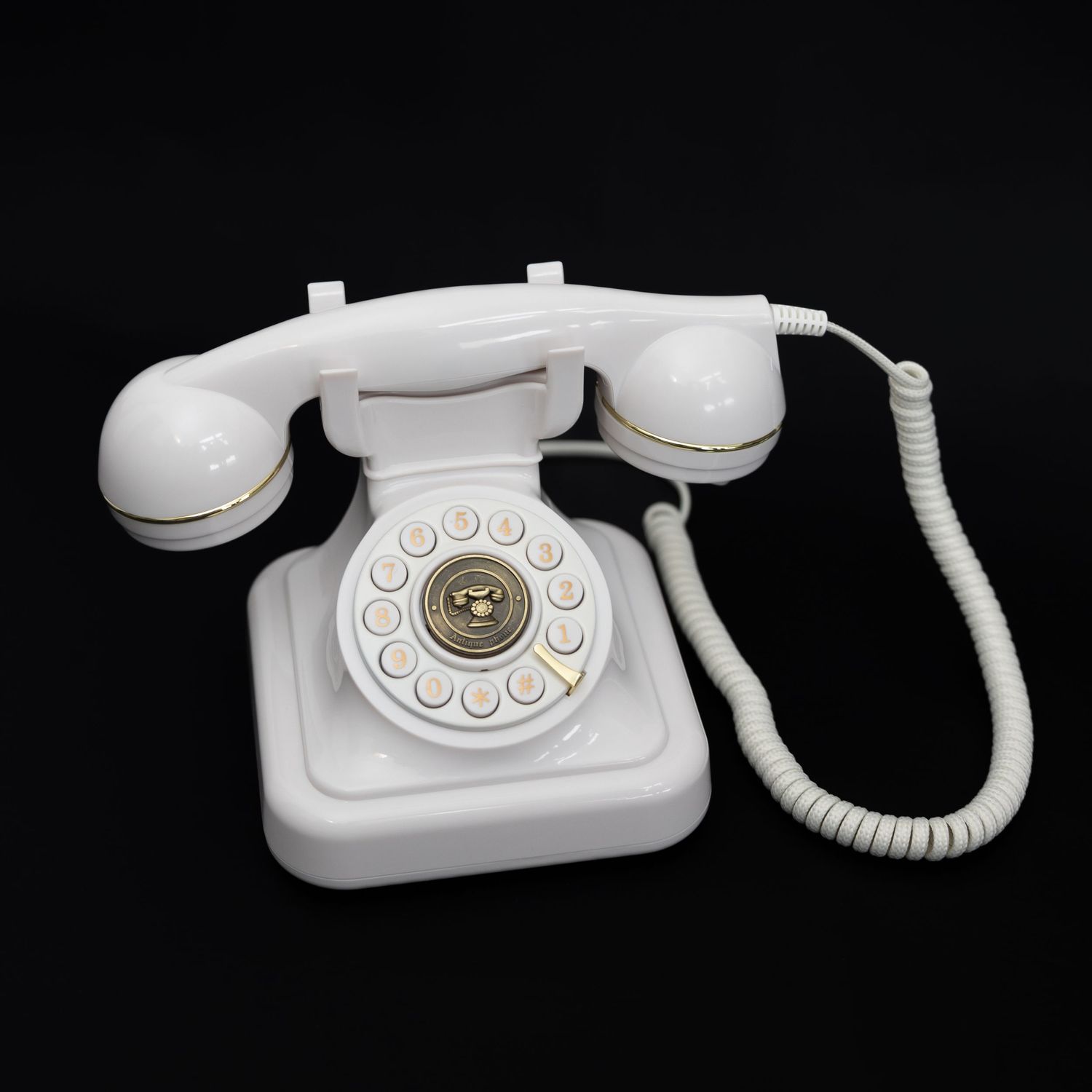 White retro telephone with rotary dial isolated on dark background.