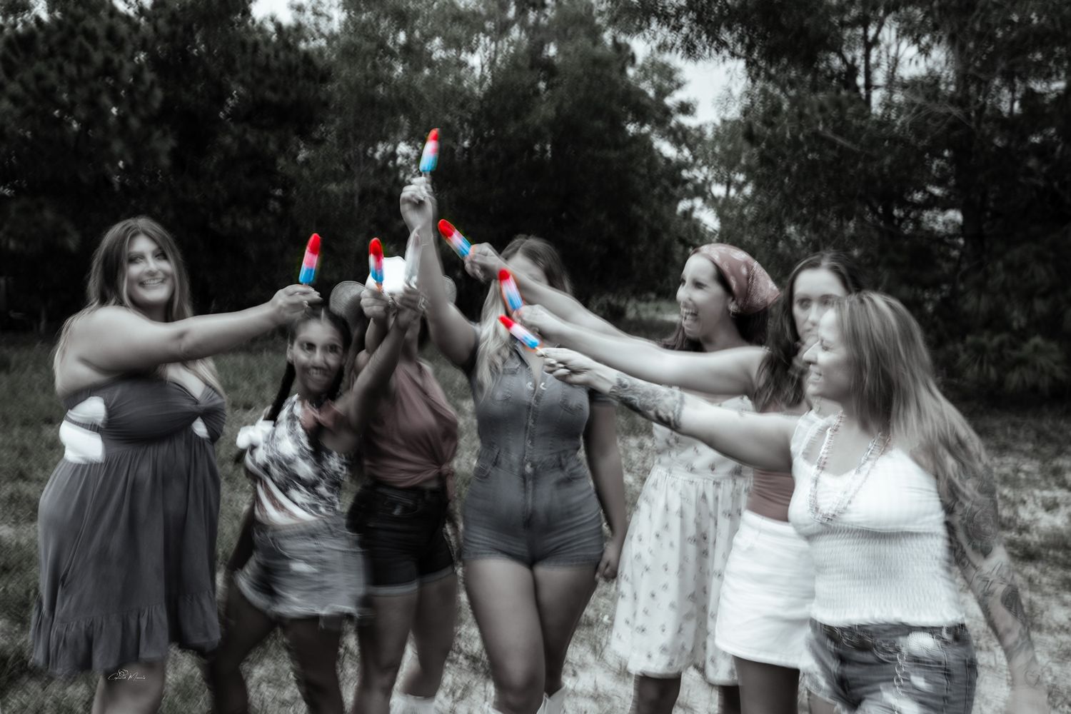 Young girls enjoying rocket pop popsicles during a Fourth of July celebration photographed by Captured Moments Photography in Southwest Flor