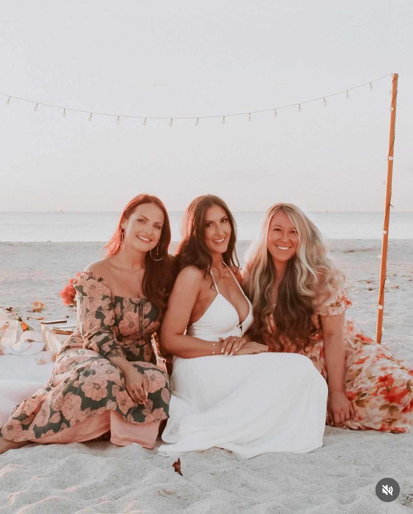 Elegant bridal picnic setup on the beach celebrating a bride-to-be during a styled bridal portrait session captured by Captured Moments Phot