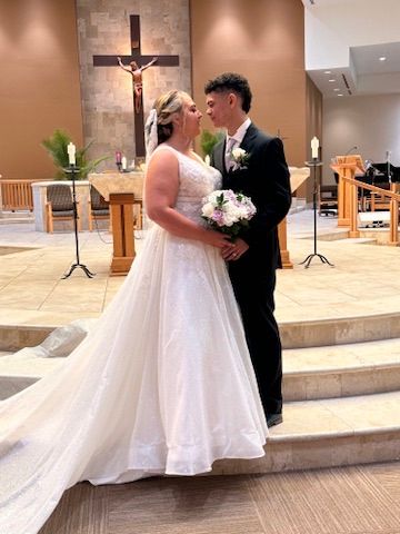 Bride and groom celebrating their wedding ceremony inside a church captured by Captured Moments Photography in Southwest Florida.