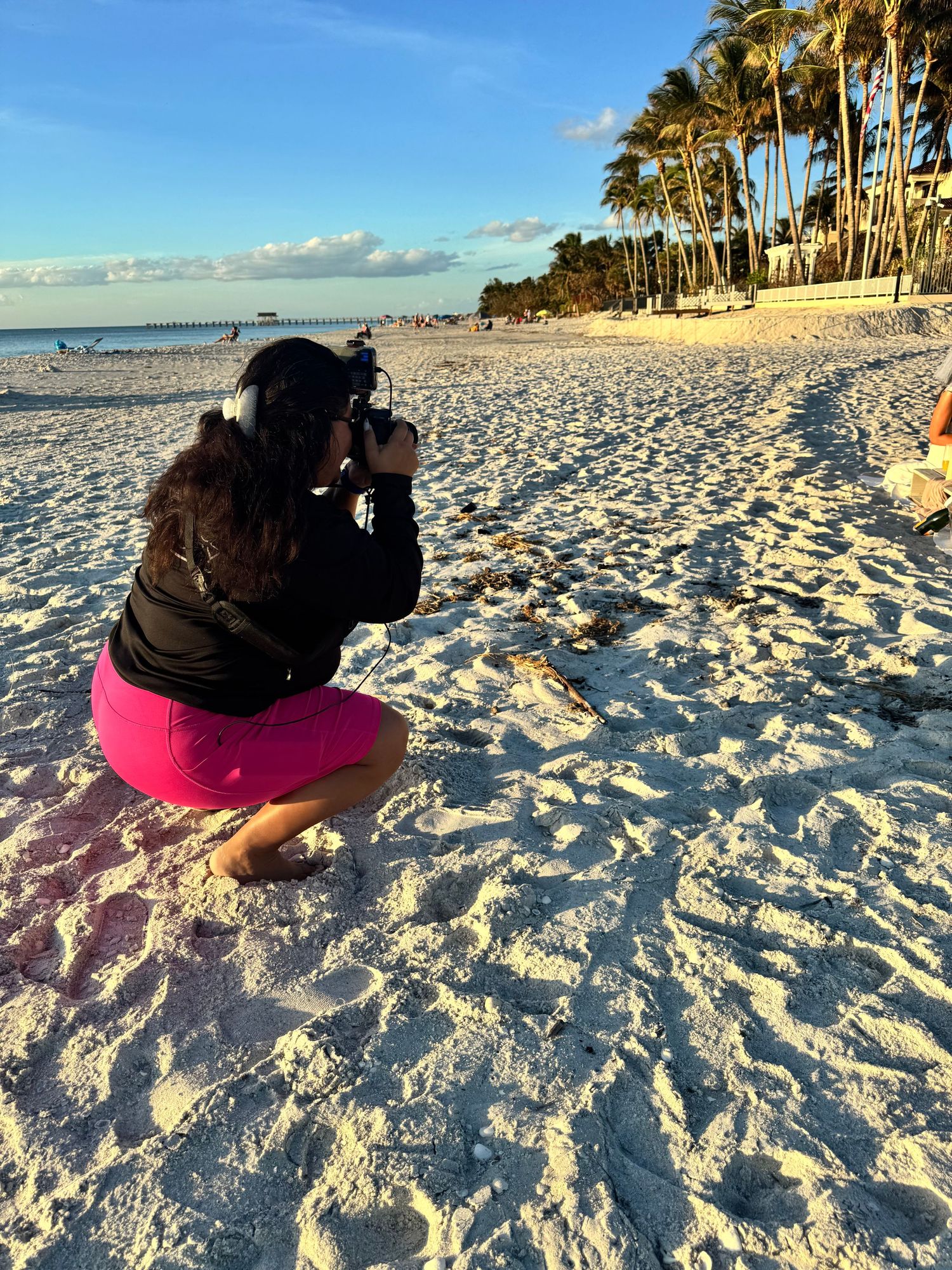 Behind the scenes of Julia Camacho capturing a family photography session on the beach for Captured Moments Photography in Southwest Florida