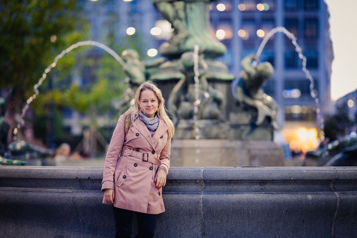 woman by donnerbrunnen in Vienna in autum