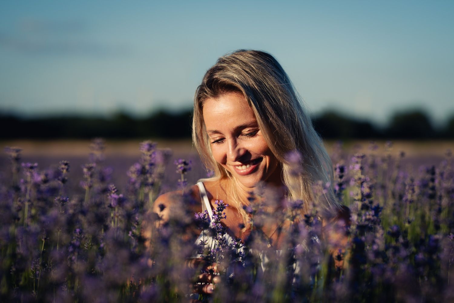 A beautiful woman smiling in a lavender field around Vienna