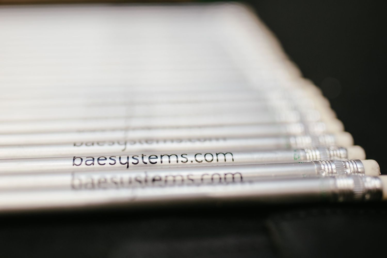 Close-up detail of white printed materials arranged in a diagonal pattern.
