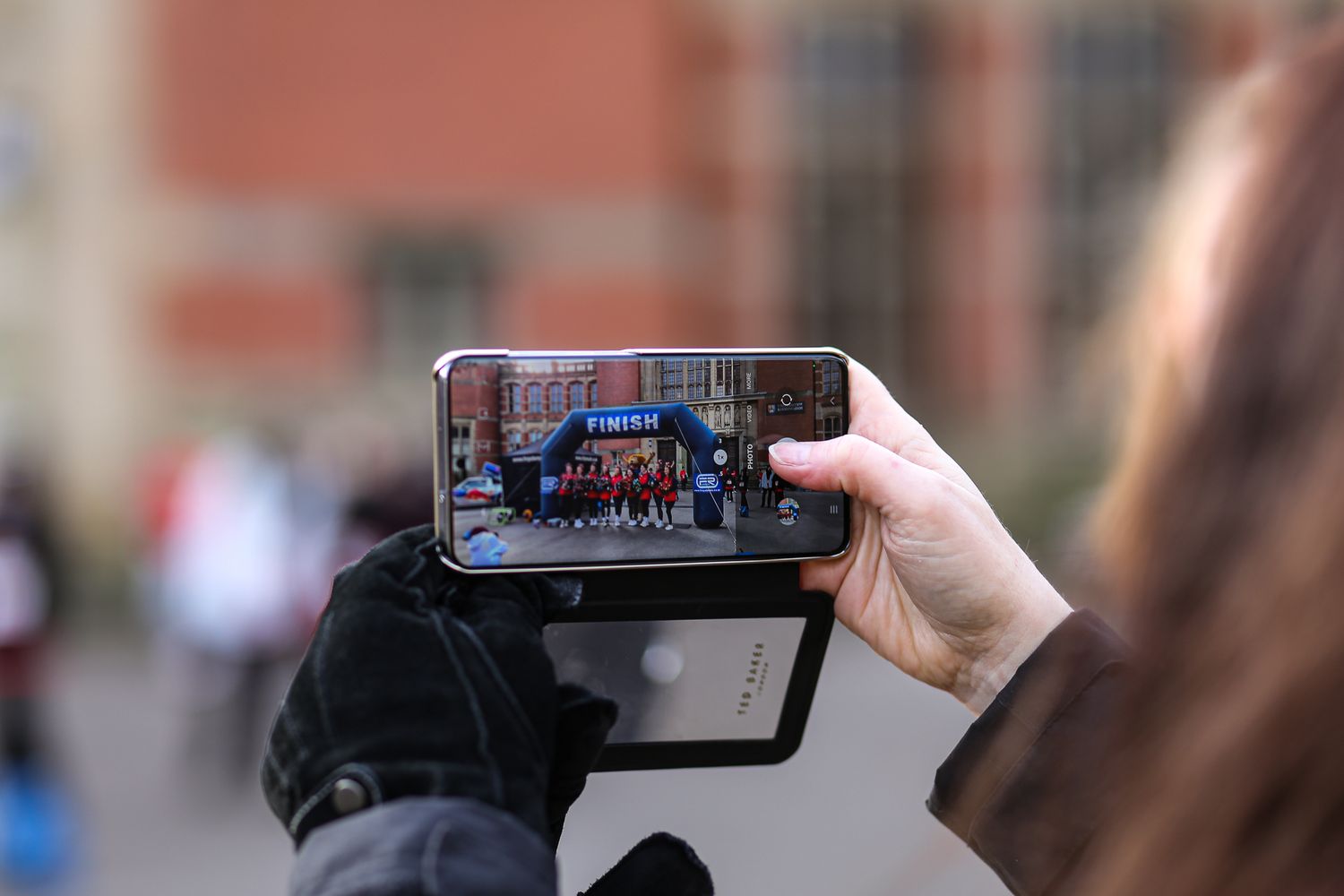 Spectators recording a sports event on mobile phones.