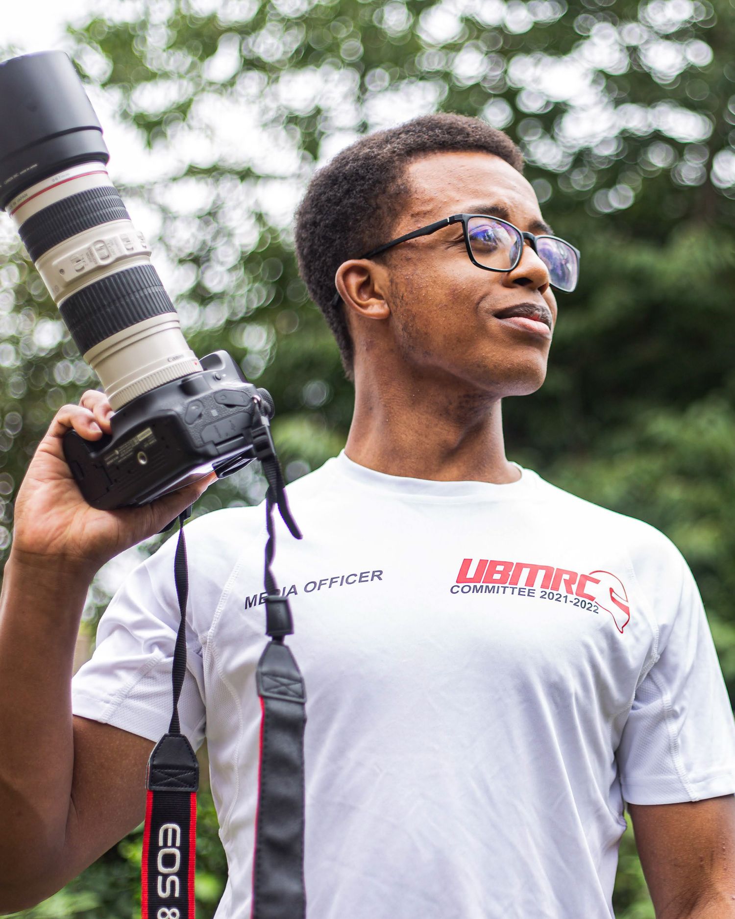 Professional camera equipment being displayed against natural outdoor backdrop portrait.