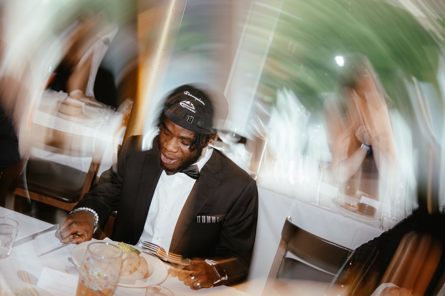 Guests mingle and chat at a formal event with drinks in hand during a lively social gathering.