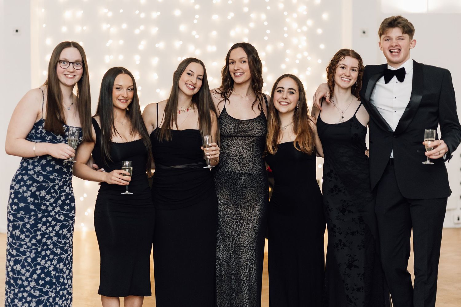 Formal group photo of event attendees wearing black and dark formal attire.