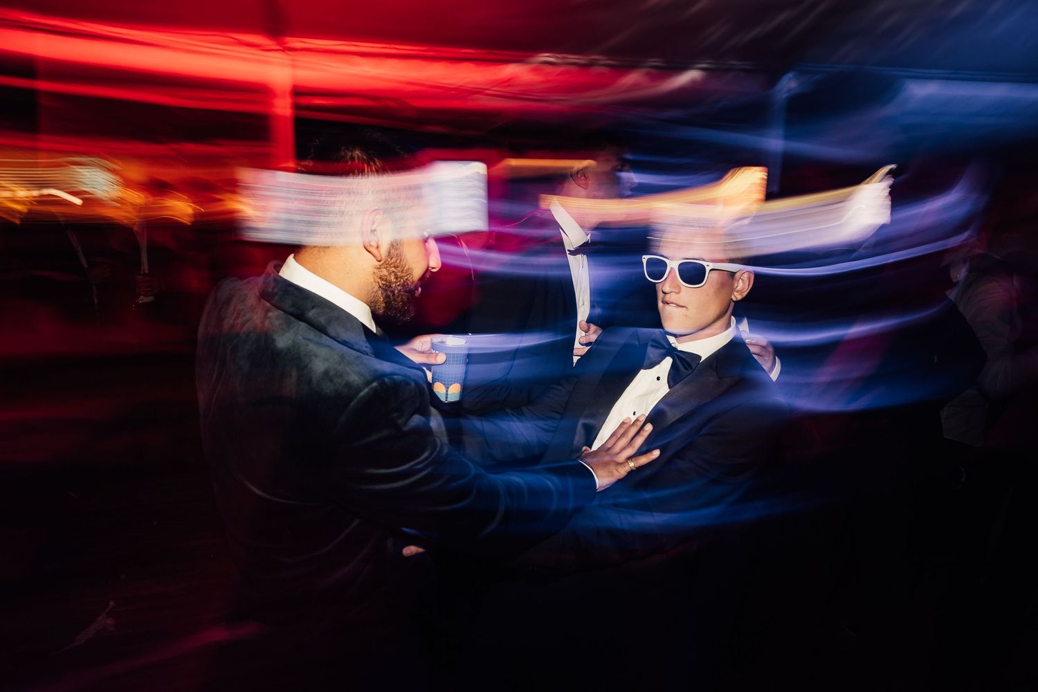 Abstract light trails in red and blue creating dynamic motion patterns.