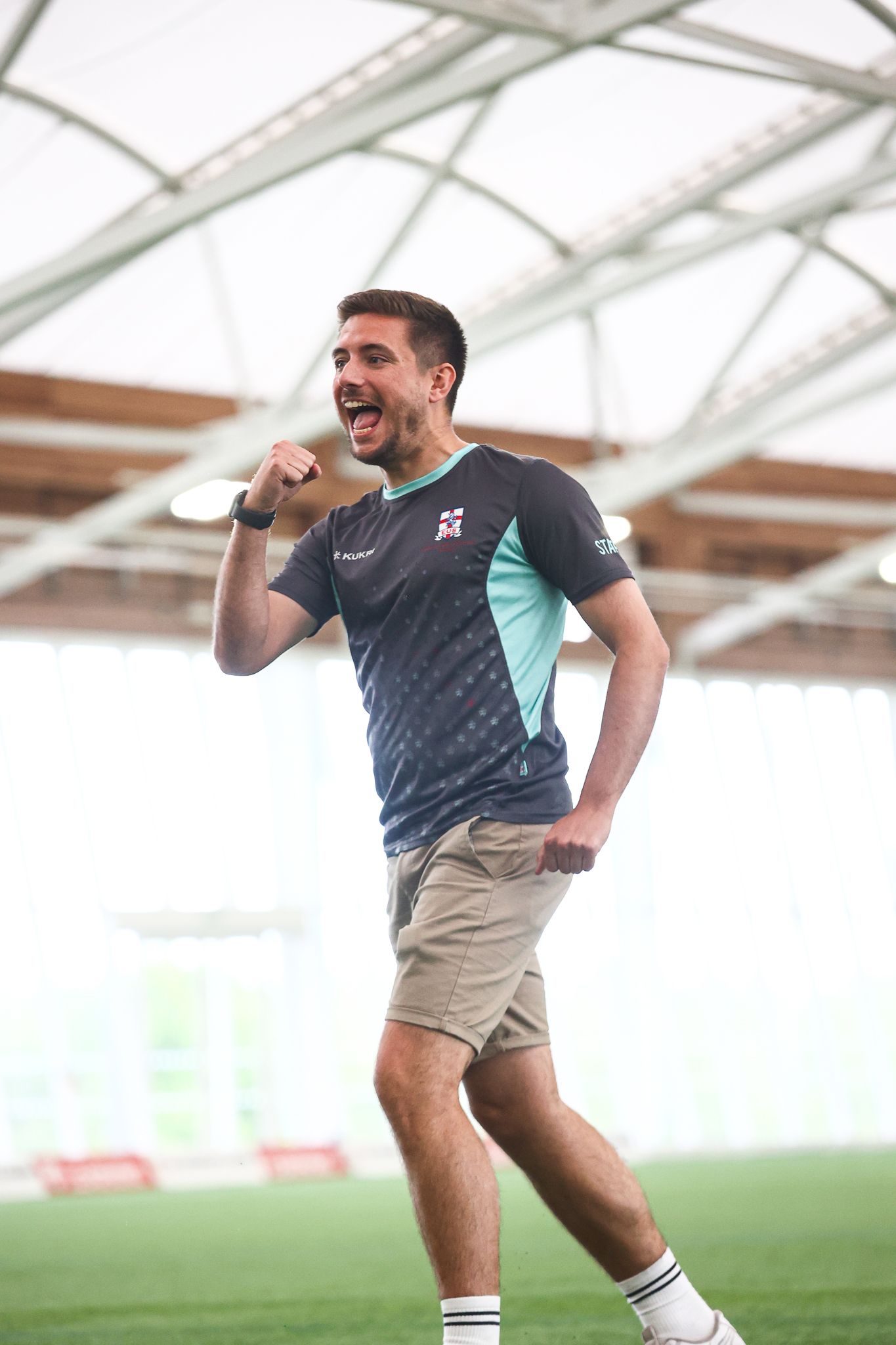Athletes demonstrating dynamic movements during indoor training session.