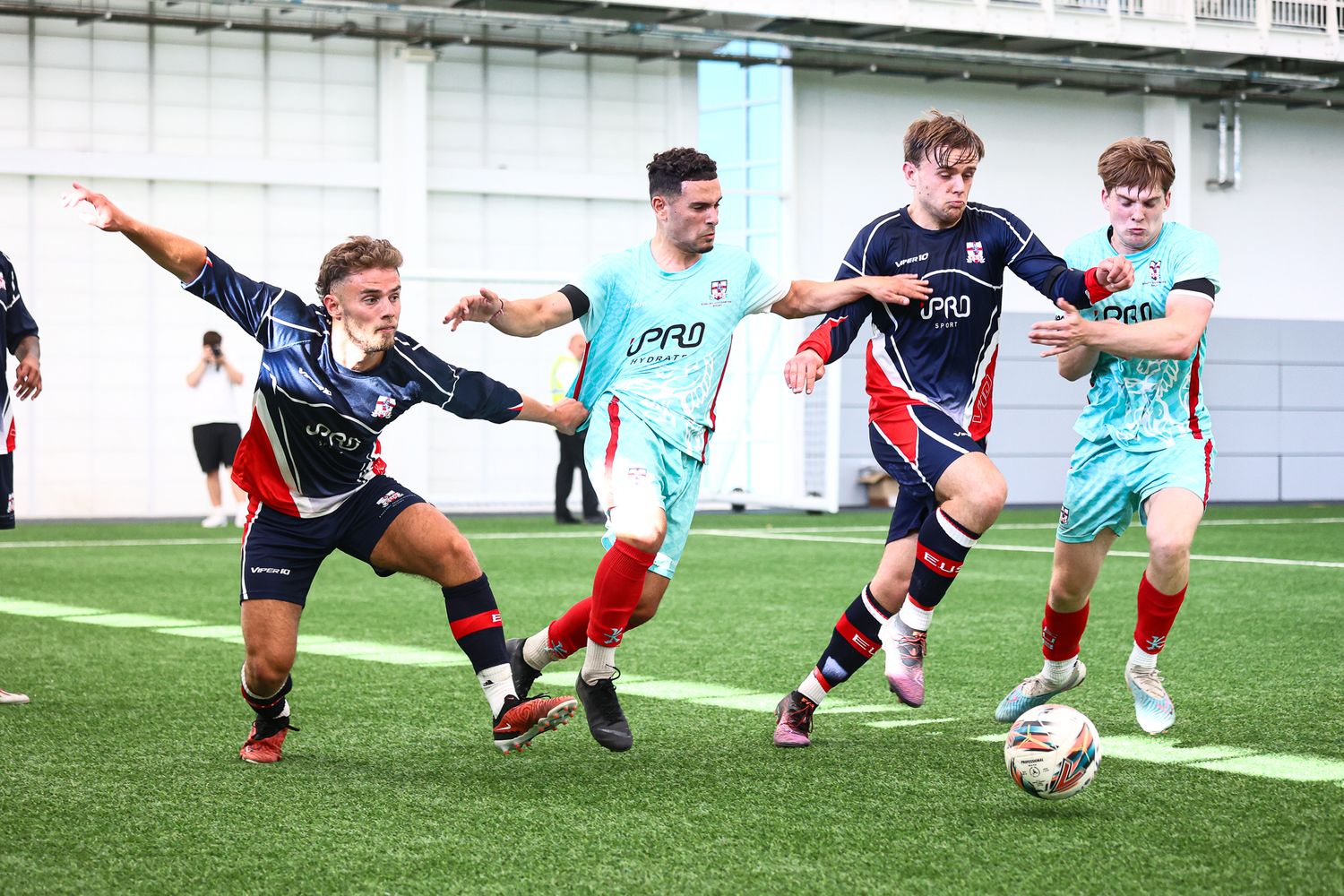 Athletes practicing diving saves and goalkeeper techniques during a soccer training session.