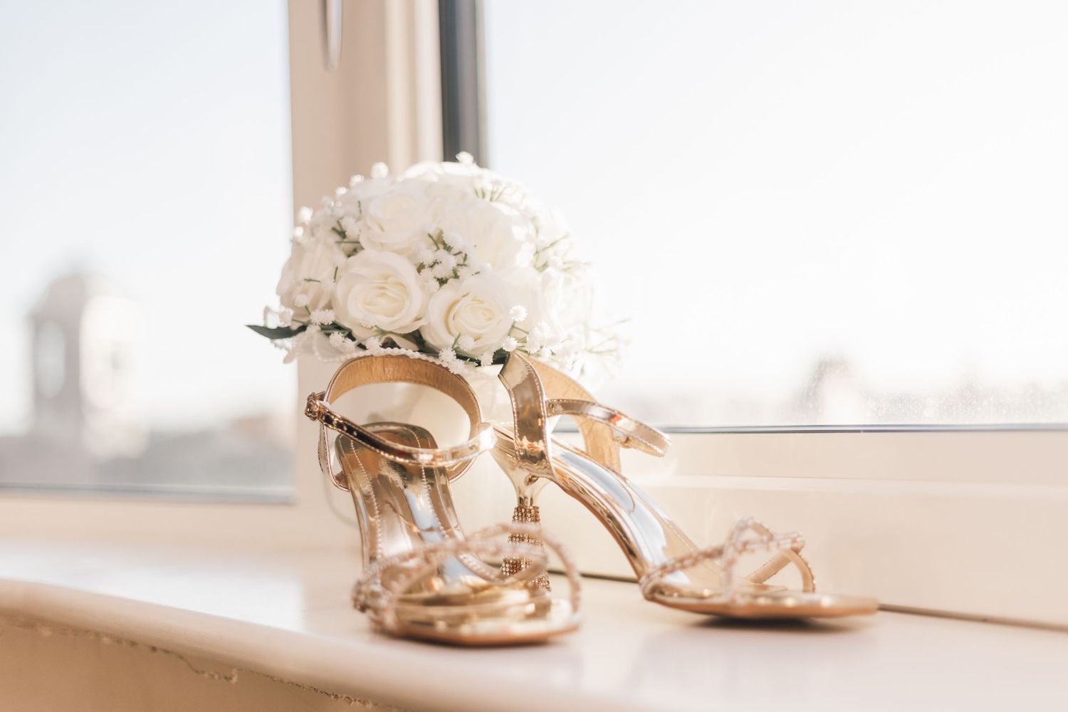 White bridal sandals and accessories arranged on a light background.