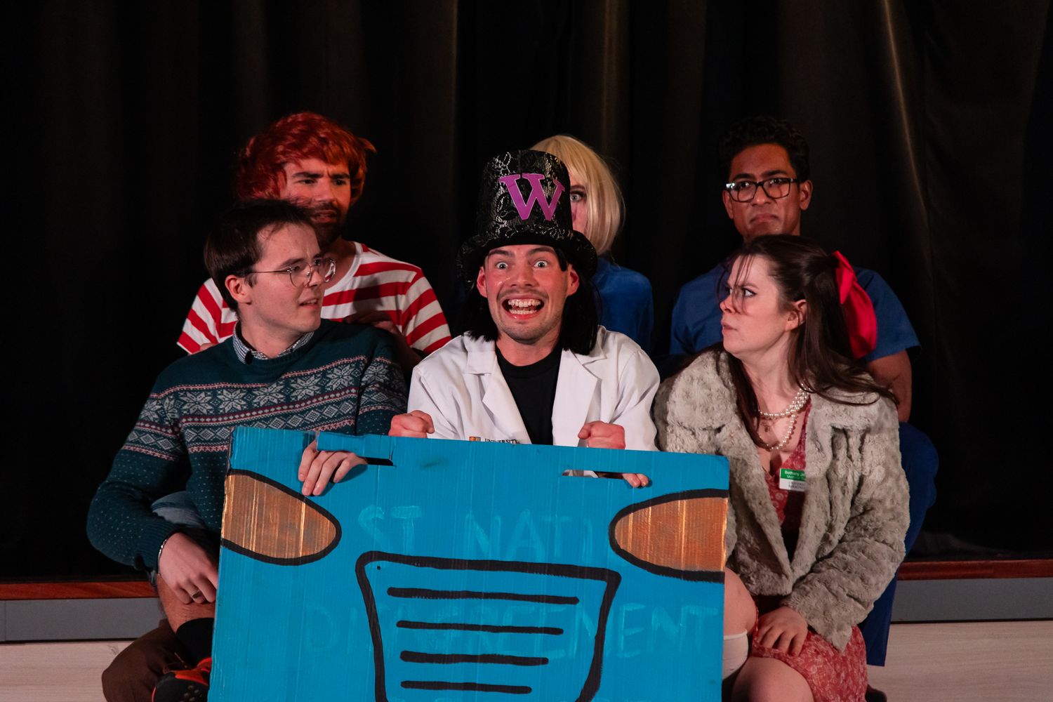 Students burst out laughing while participating in an improv comedy class exercise.