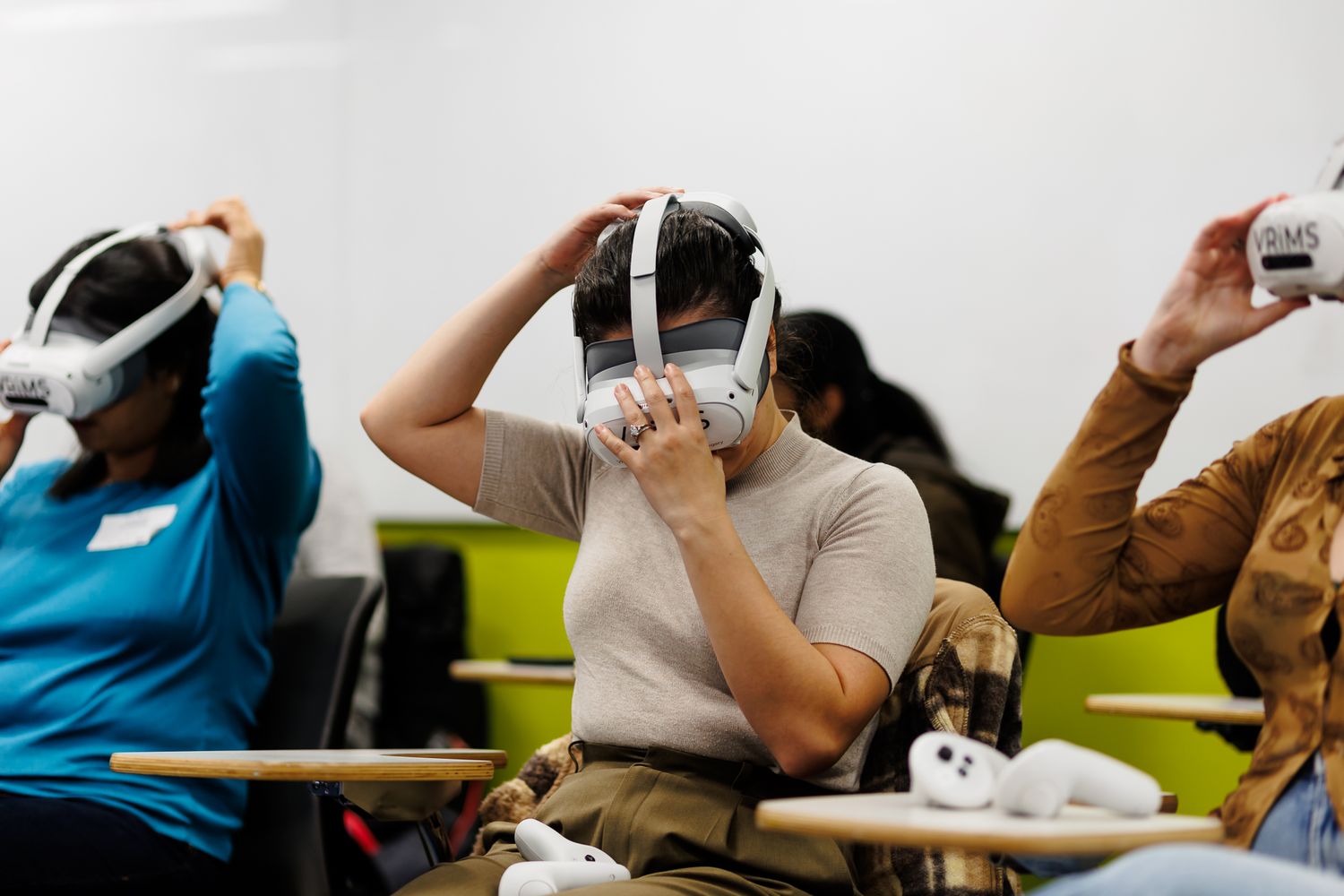 Multiple people wearing VR headsets participate in an interactive virtual reality session.