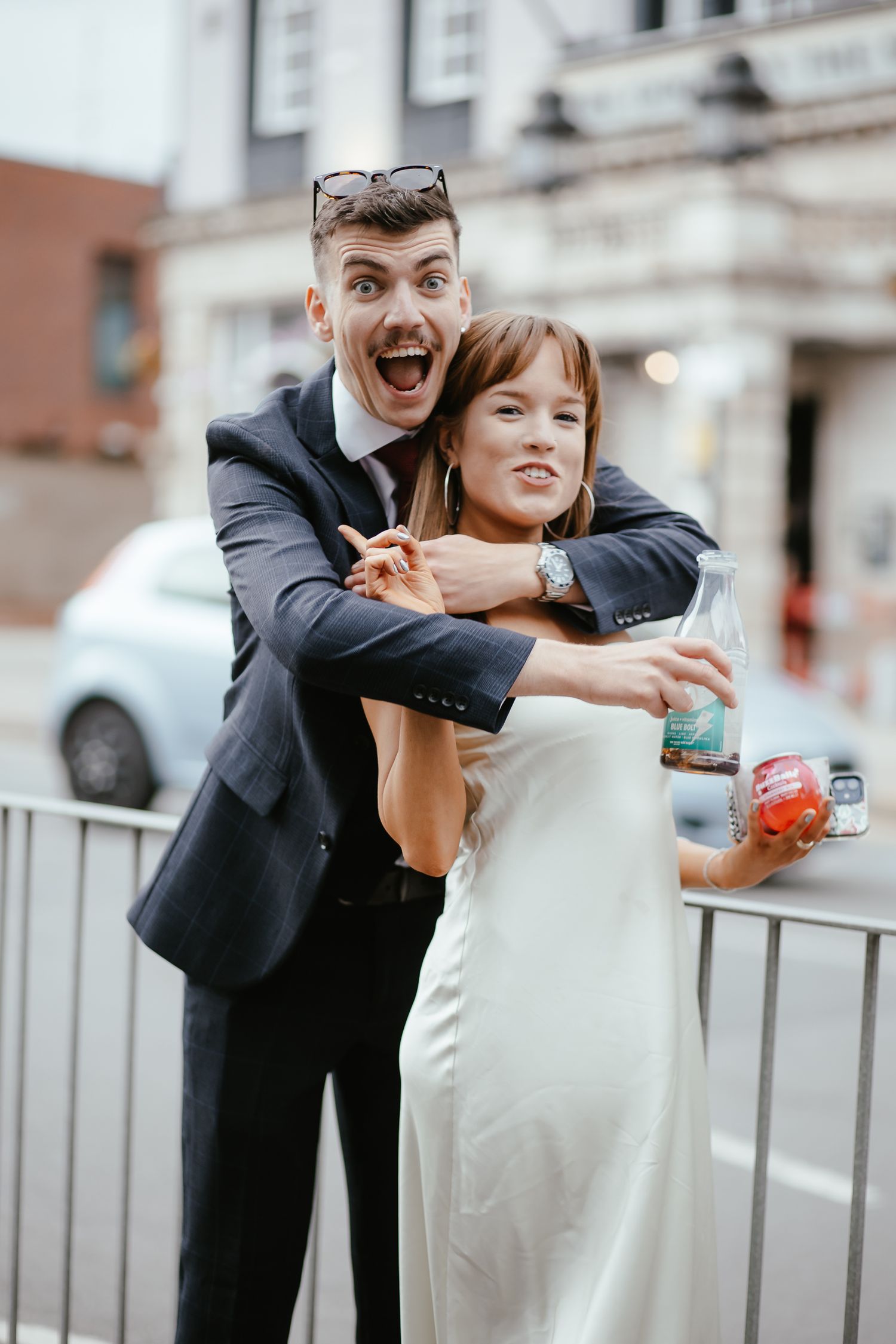 Candid sequence of a couple playfully posing and laughing together on an urban street.
