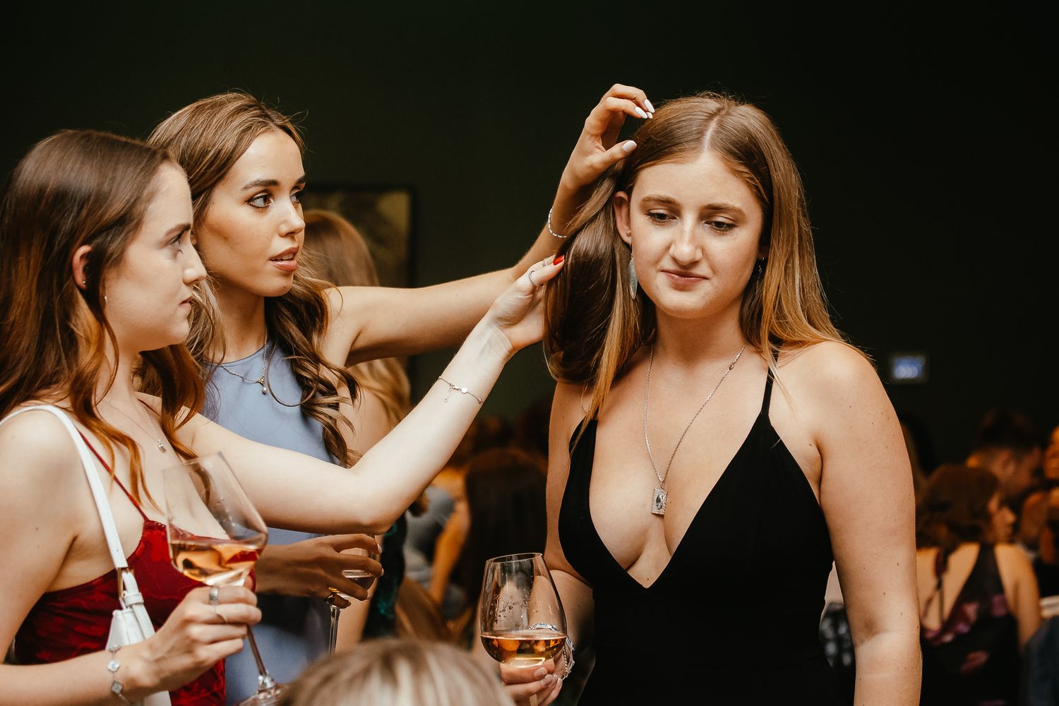Candid moments of celebration captured at a dimly lit evening reception.