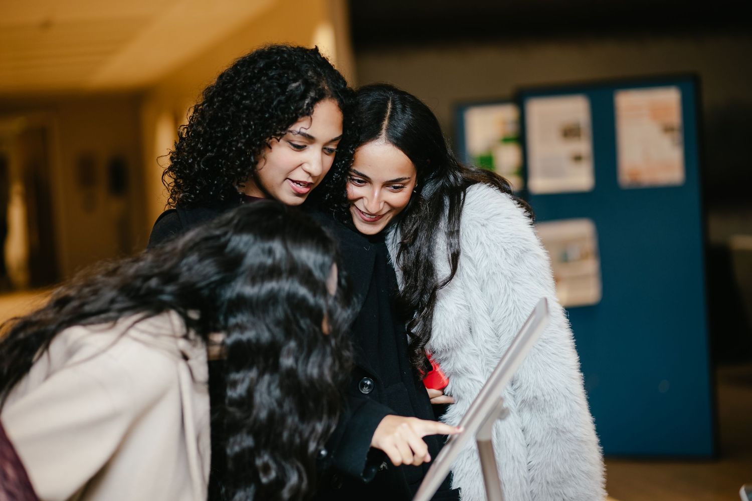 Group of attendees sharing a warm embrace at a formal evening function.