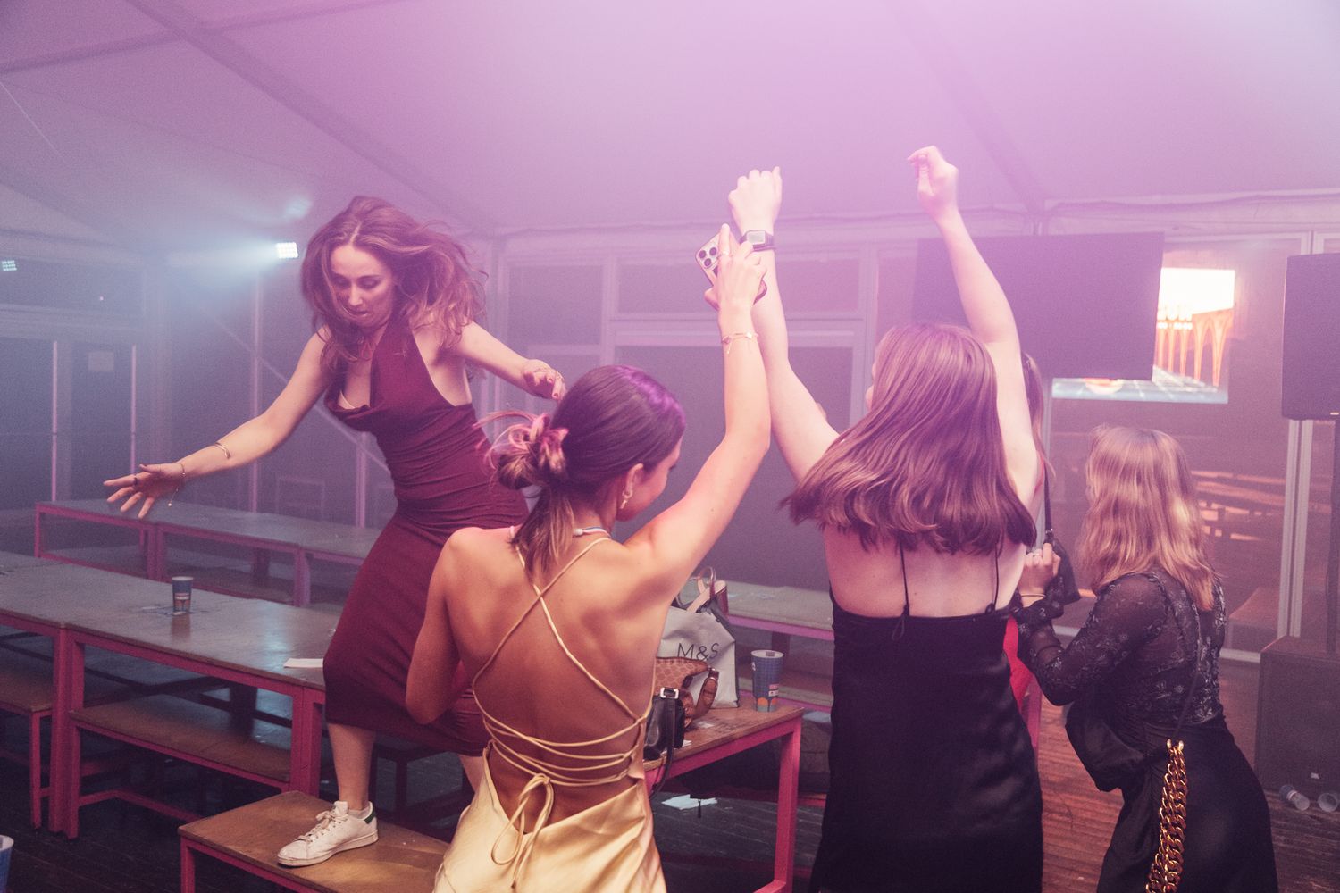 Dance party with pink and purple lighting effects.