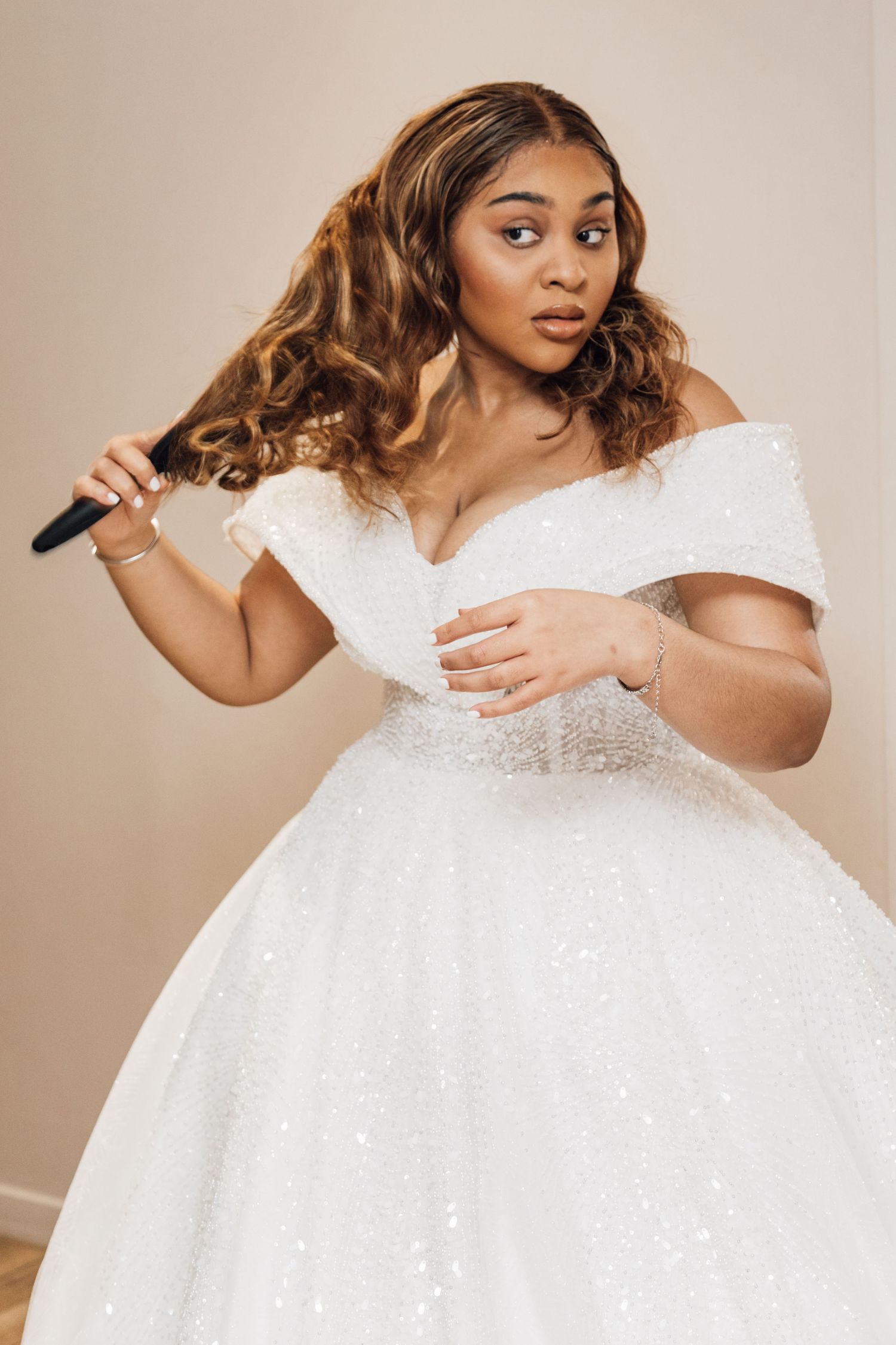 Close-up shots of a sparkling white wedding gown with intricate beaded details.