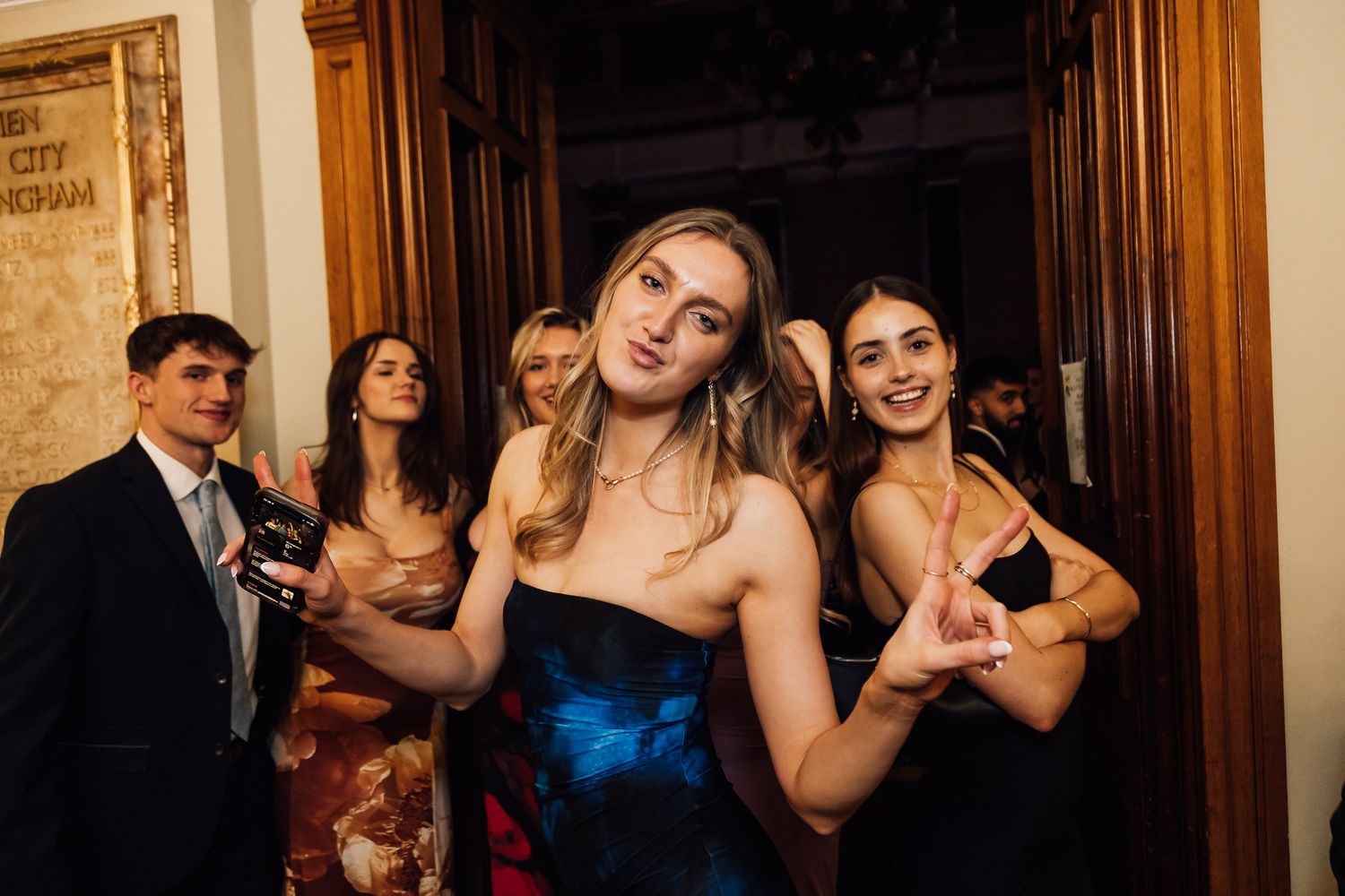 Party guests dancing and celebrating in an elegant venue.
