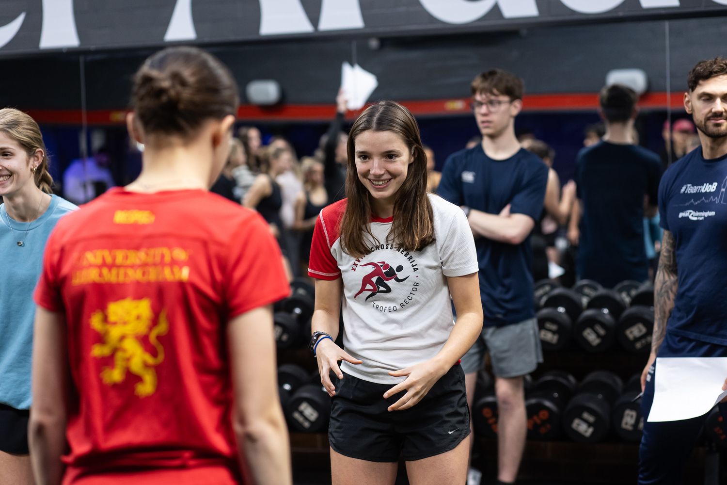 Group of athletes training together in a modern indoor gymnasium setting.