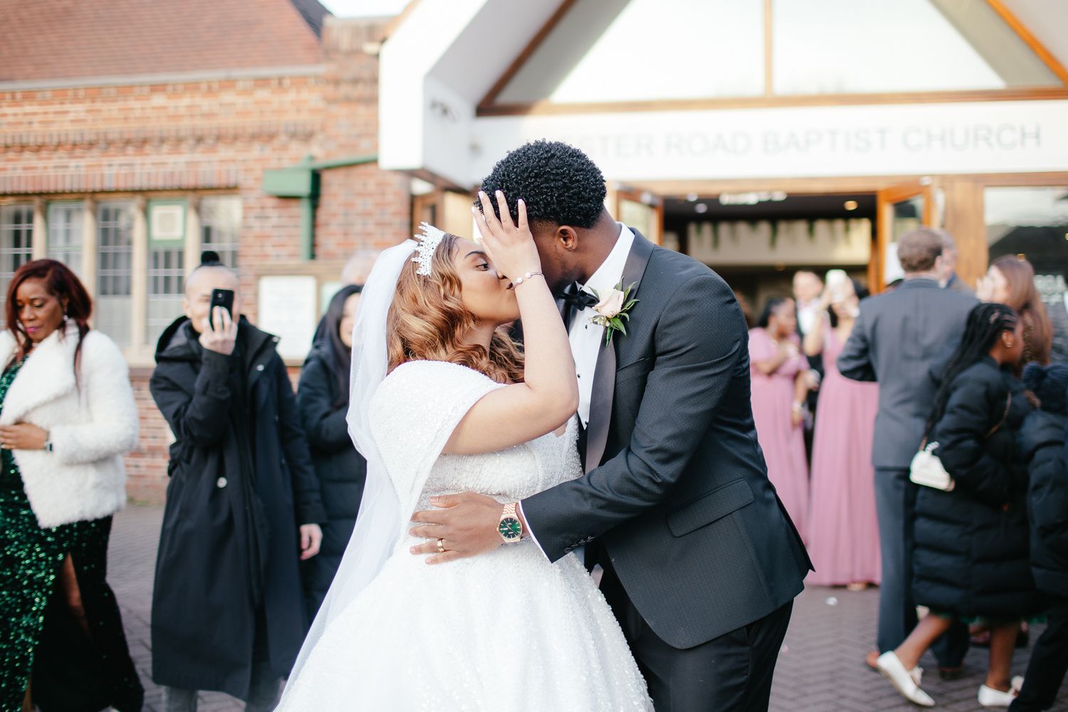 Wedding ceremony guests celebrating outdoors with joyful expressions in Birmingham