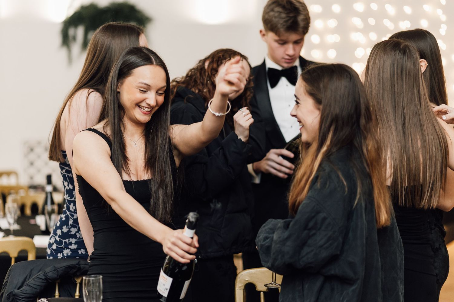 Group of attendees socializing during a formal evening event.