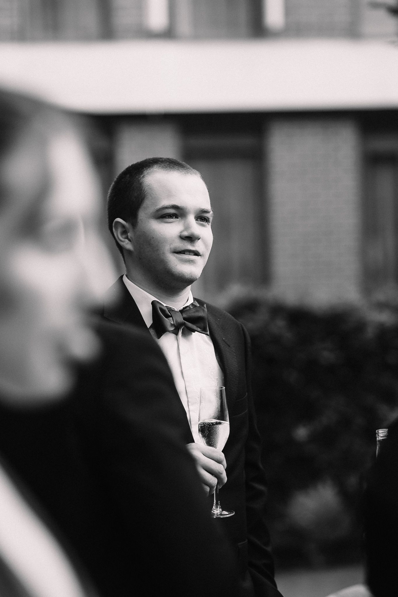 Black and white portrait series of someone holding a champagne glass.