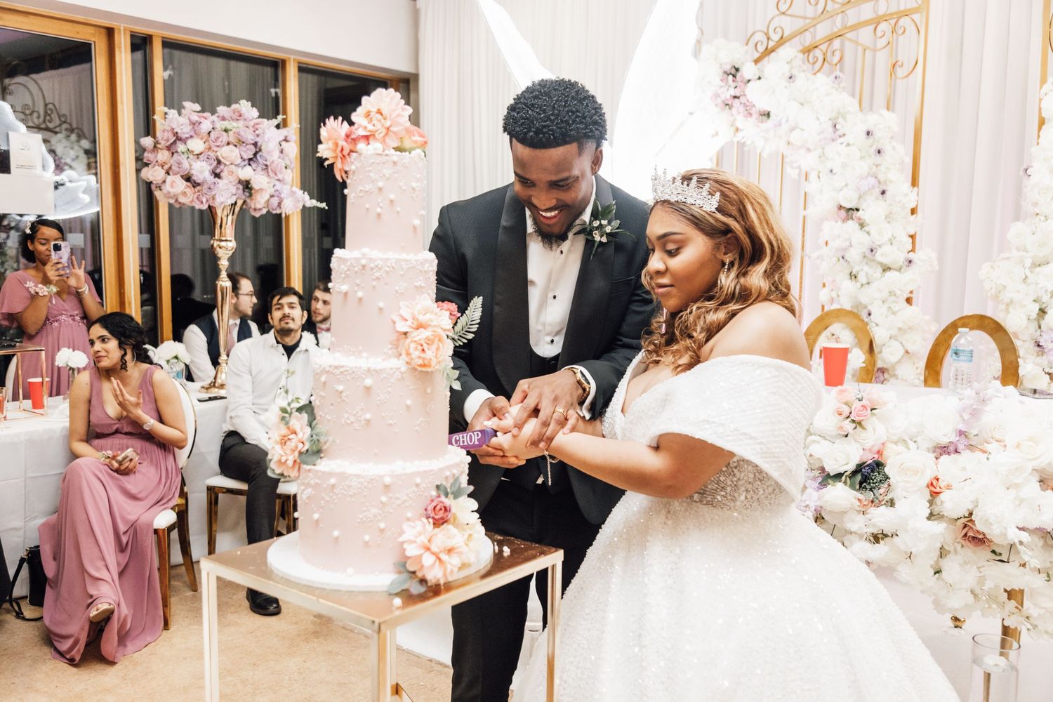 Wedding venue decorated with romantic floral arches and pink cherry blossoms.