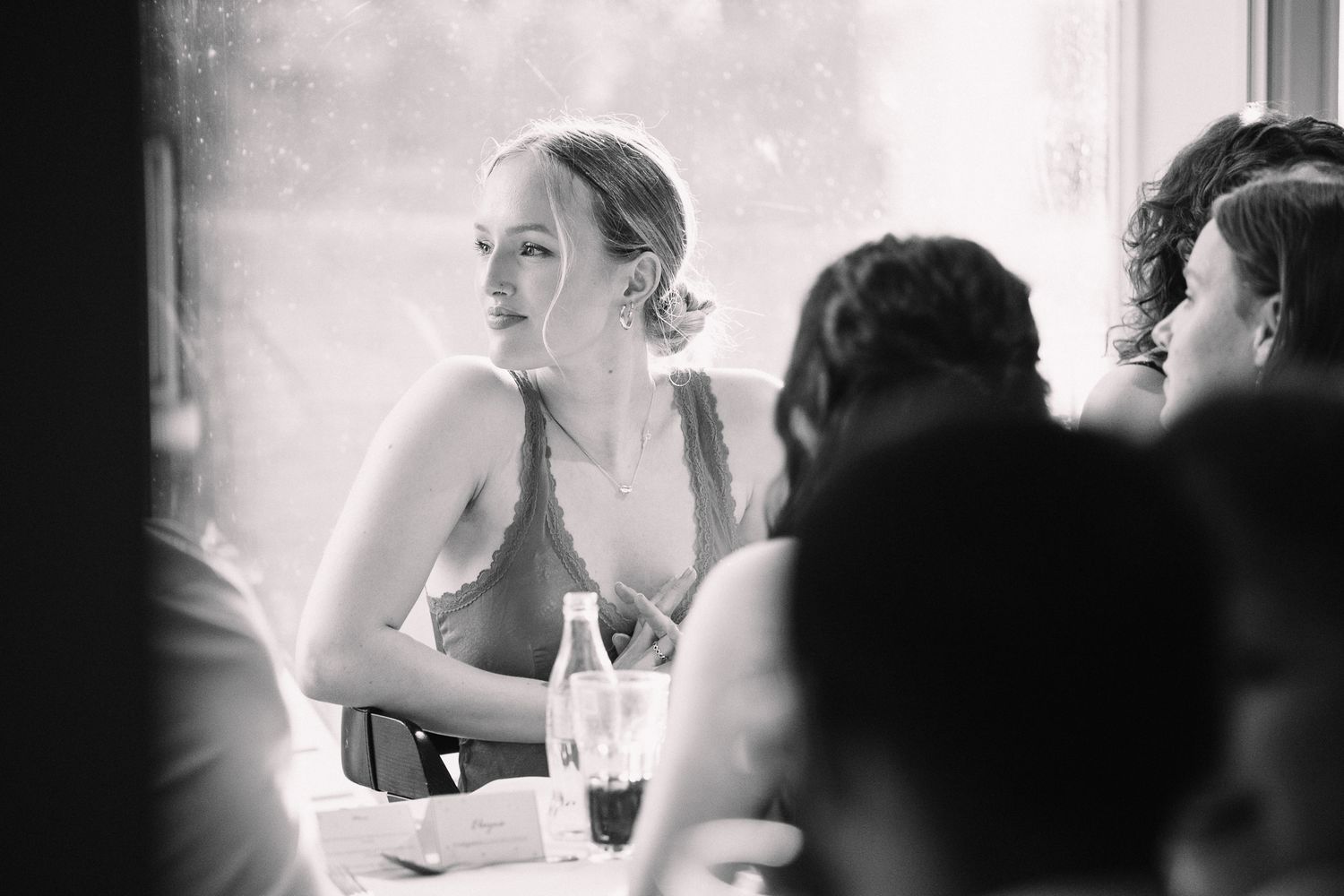 People socializing at a formal dinner event with elegant table settings and ambient lighting.