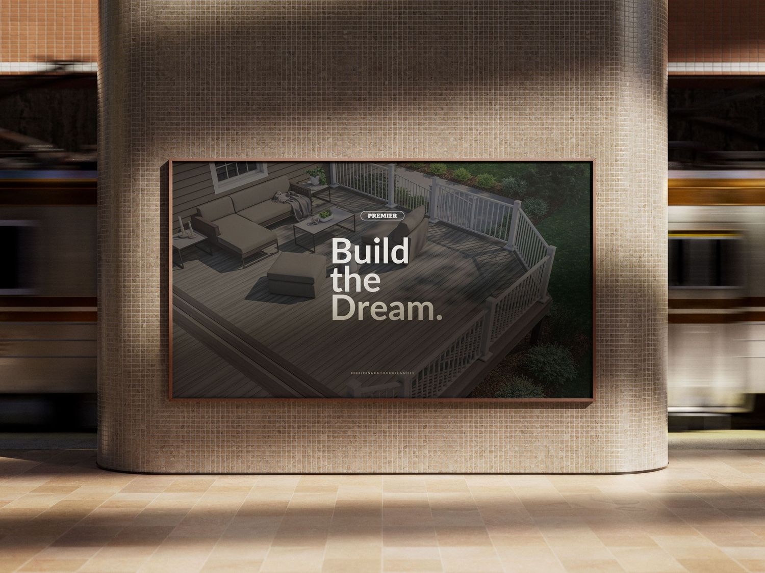 A digital billboard displaying 'Build the Dream' slogan with an aerial view of a modern outdoor deck design.