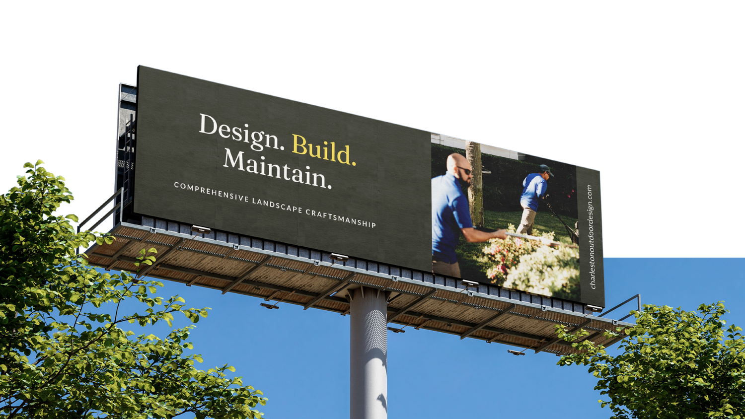 Roadside billboard reading Design. Build. Maintain. with a photo of landscapers working outdoors, set against a blue sky and green treetops.