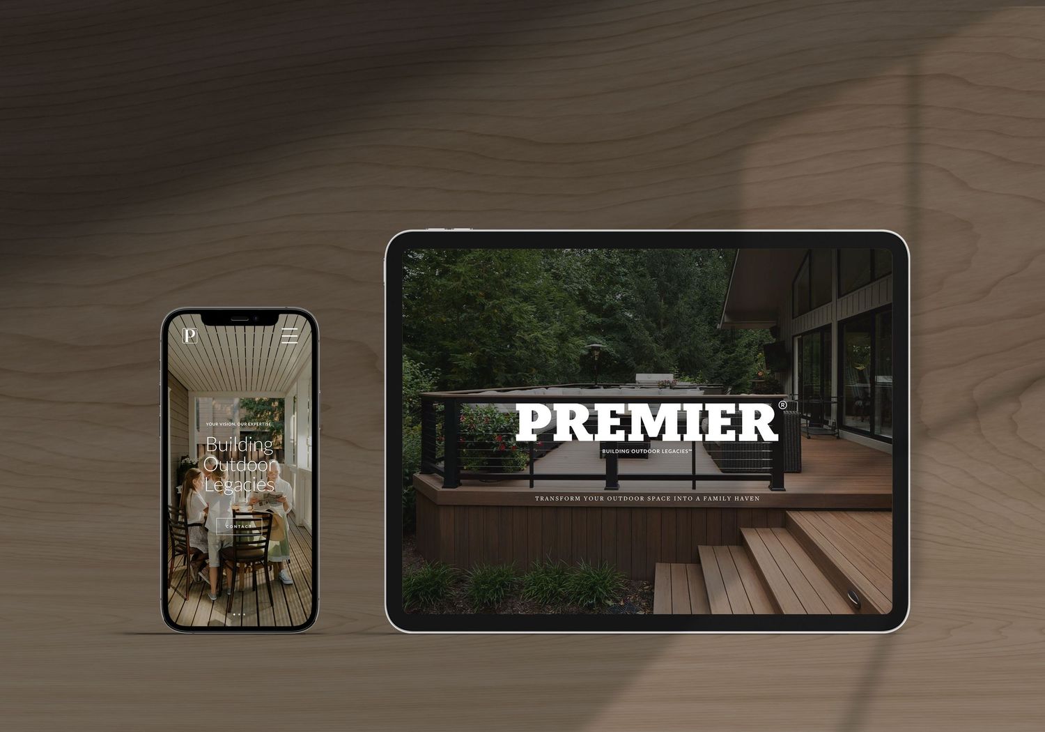 Mockup of a Premier website displayed on a tablet and smartphone against a wooden background.