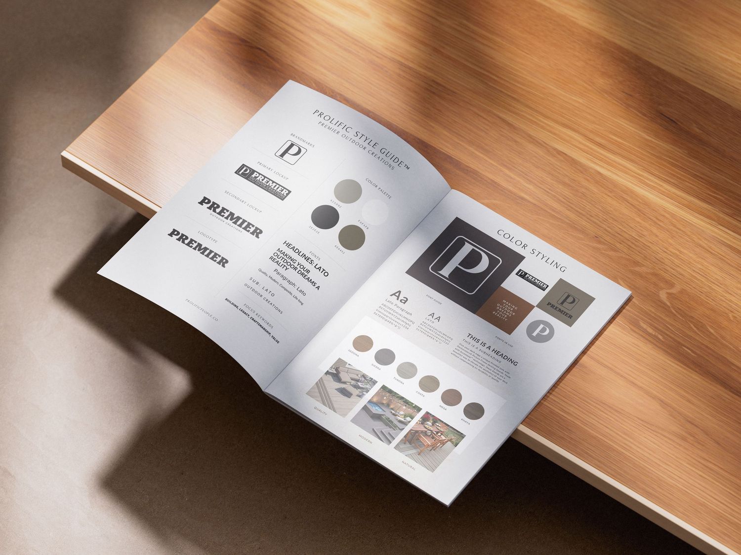 Open brand identity booklet showcasing Premier logo, typography, color palette, and design elements on a wooden surface.