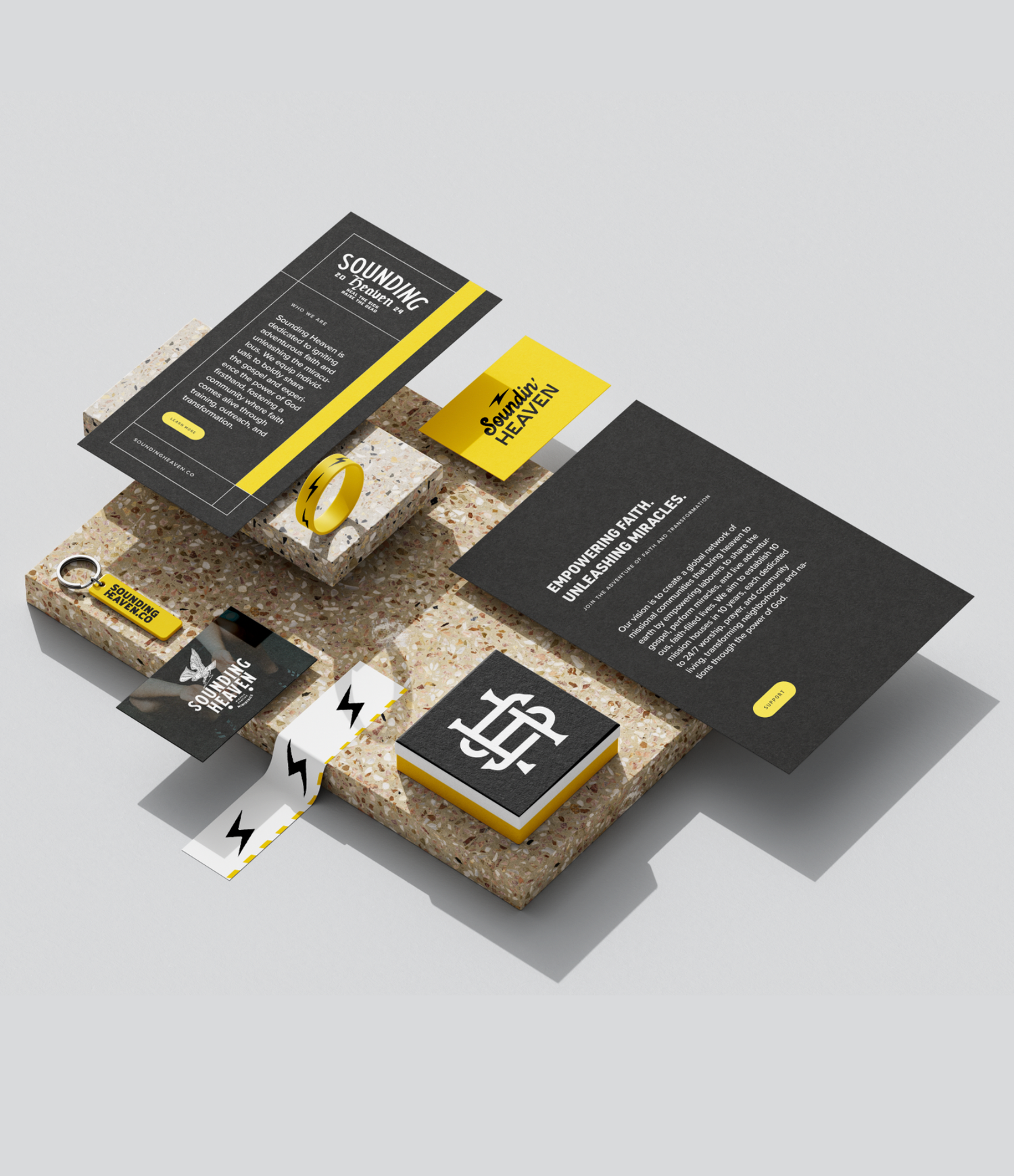 Modern business cards and brochures arranged in an elegant mockup layout with black and yellow color scheme.